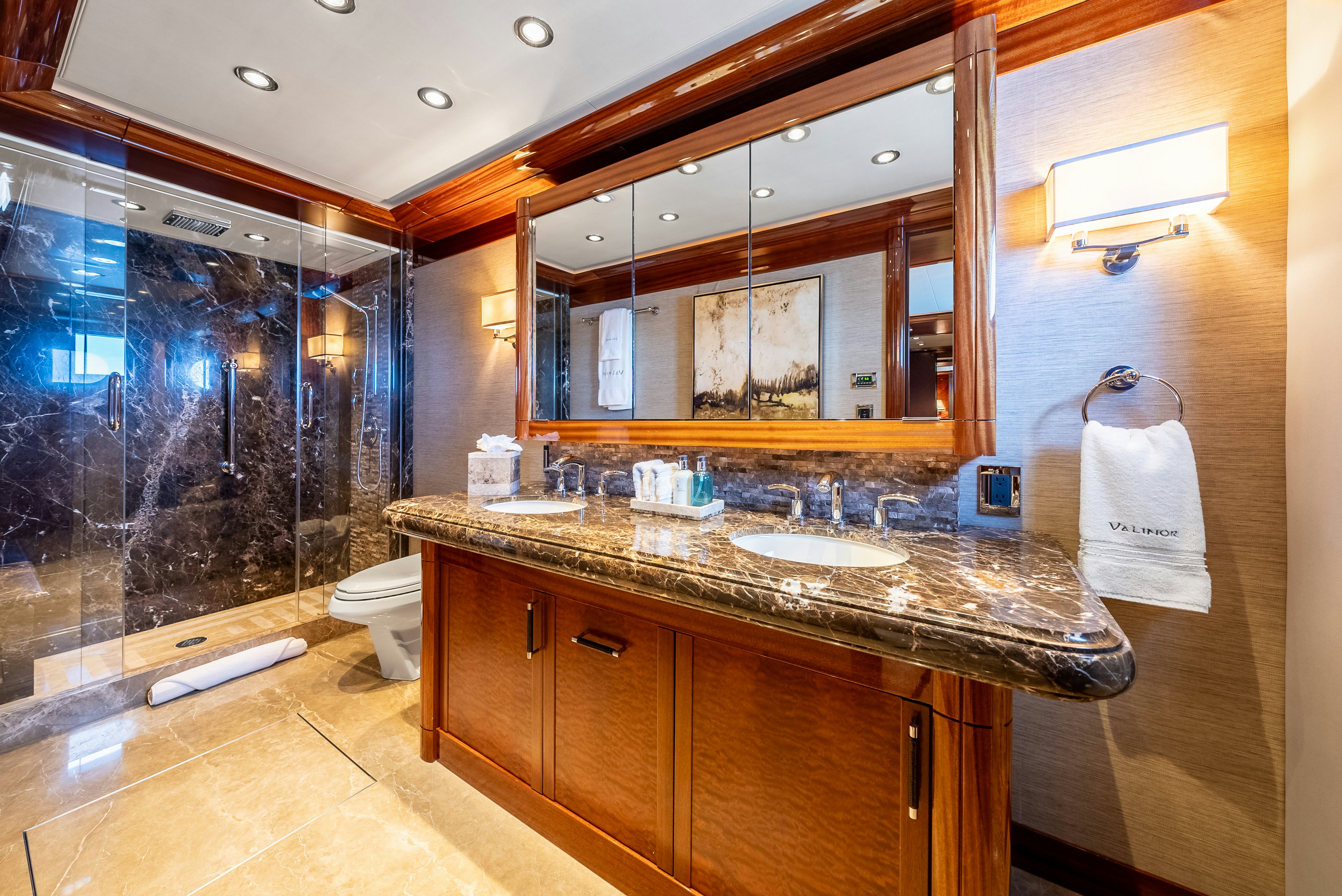 a bathroom with a countertop sink and a large mirror aboard VALINOR Yacht for Sale