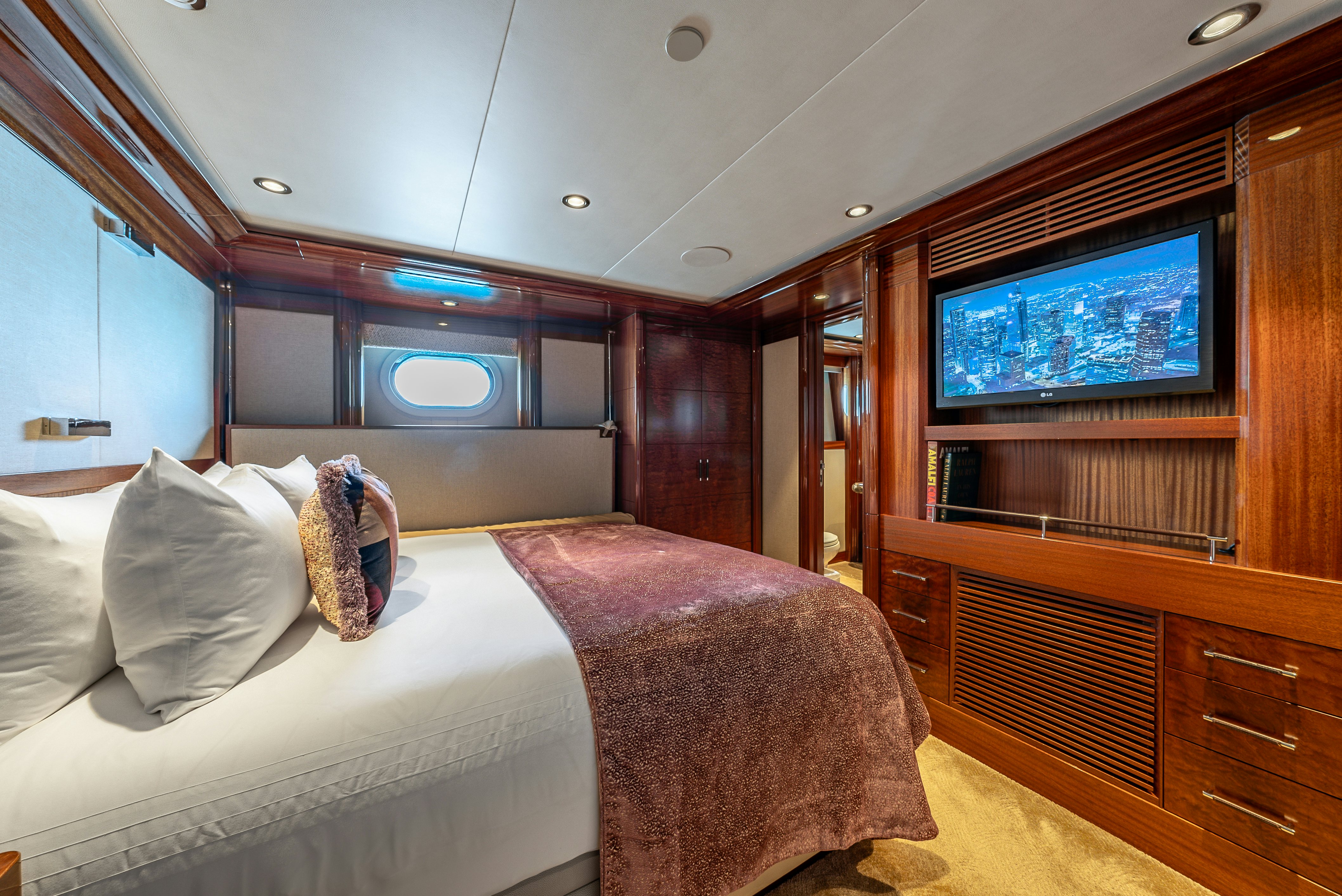 a room with a bed and a tv aboard VALINOR Yacht for Sale
