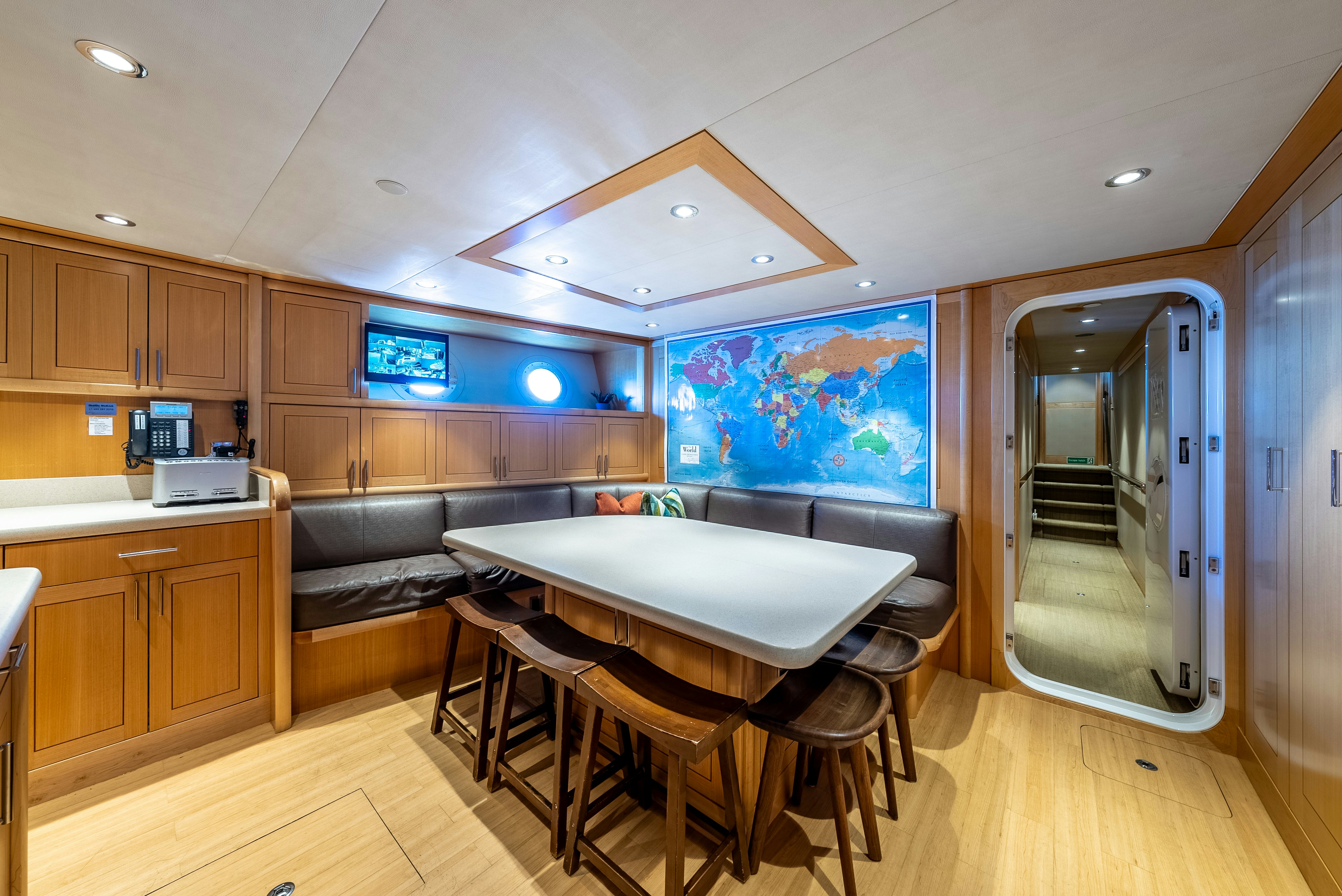 a kitchen with a table and chairs aboard VALINOR Yacht for Sale