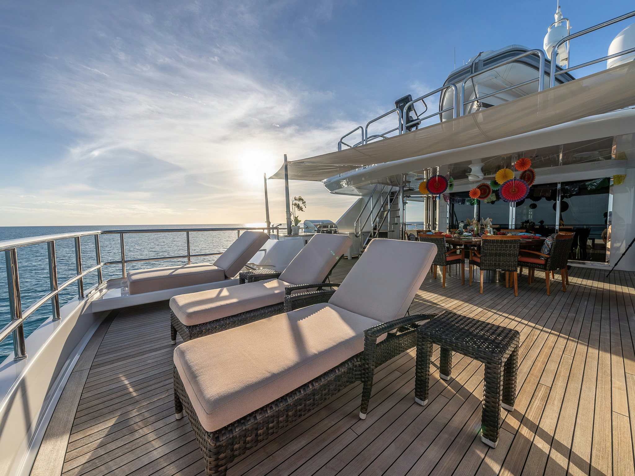 a deck with chairs and tables on it aboard VALINOR Yacht for Charter