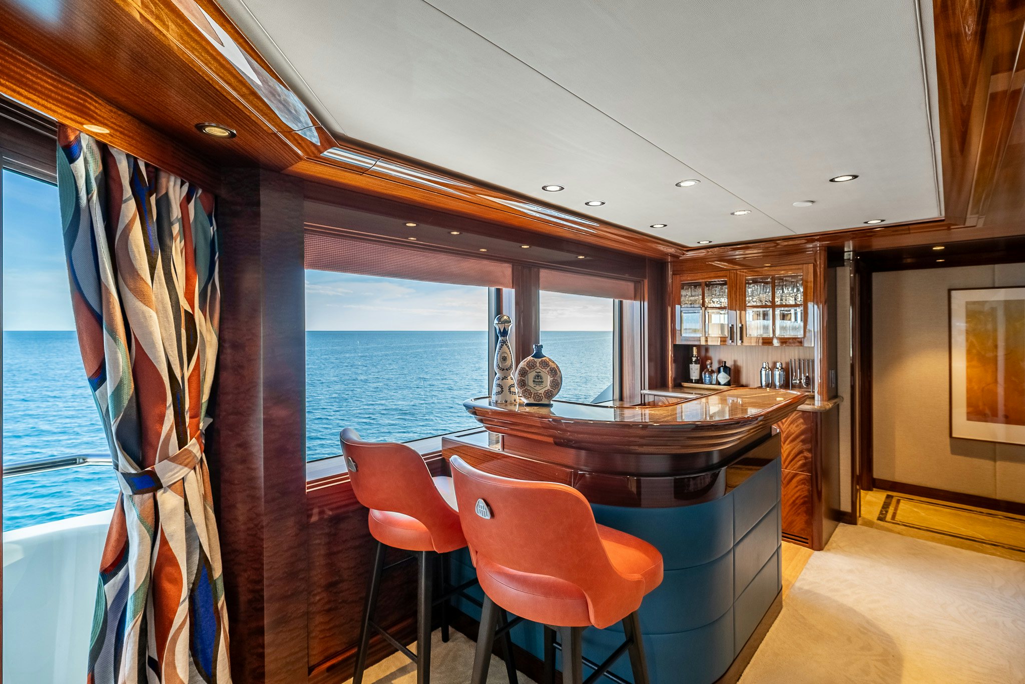a kitchen with a bar and a table and chairs aboard VALINOR Yacht for Charter
