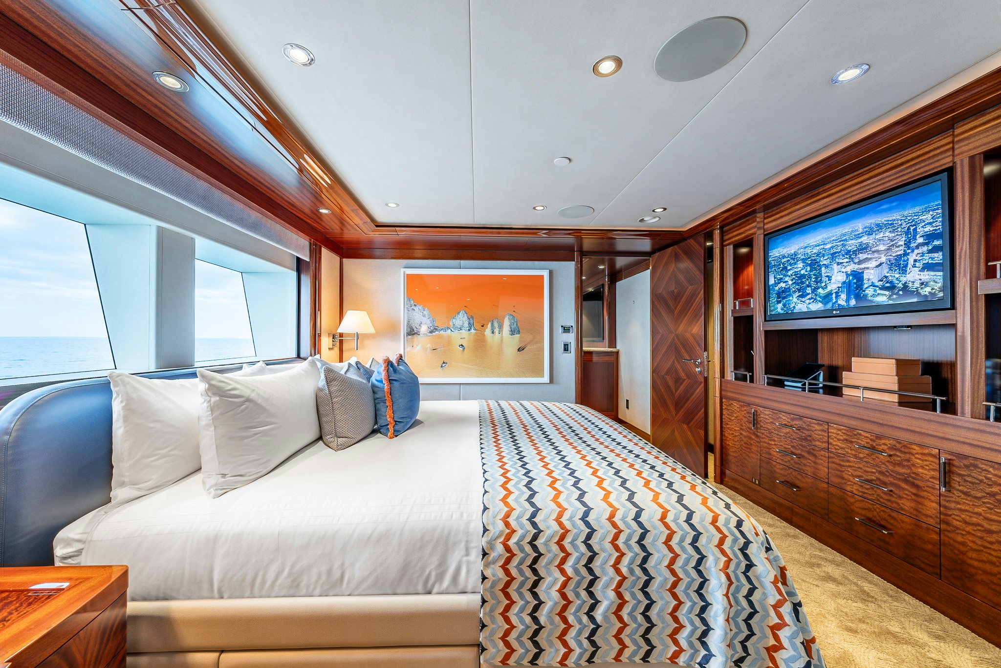 a bedroom with a bed and a dresser aboard VALINOR Yacht for Charter