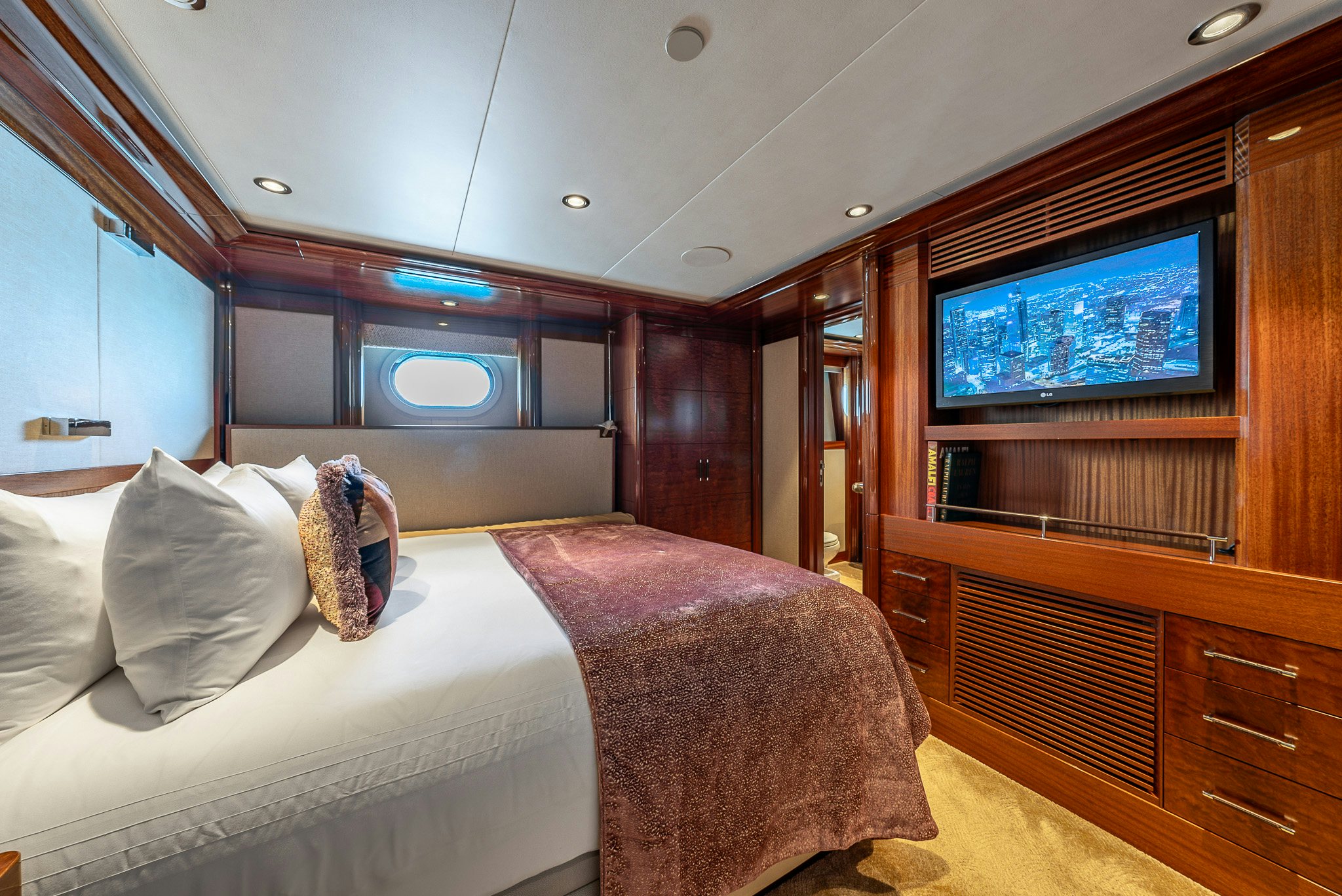 a room with a bed and a tv aboard VALINOR Yacht for Charter