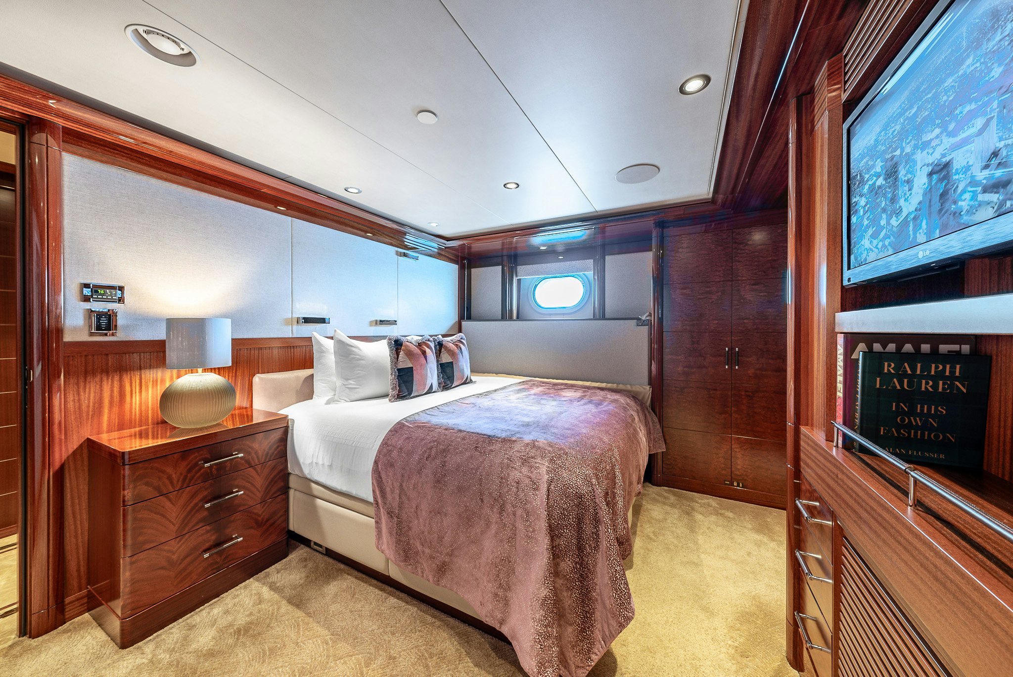 a room with a bed and a desk aboard VALINOR Yacht for Charter