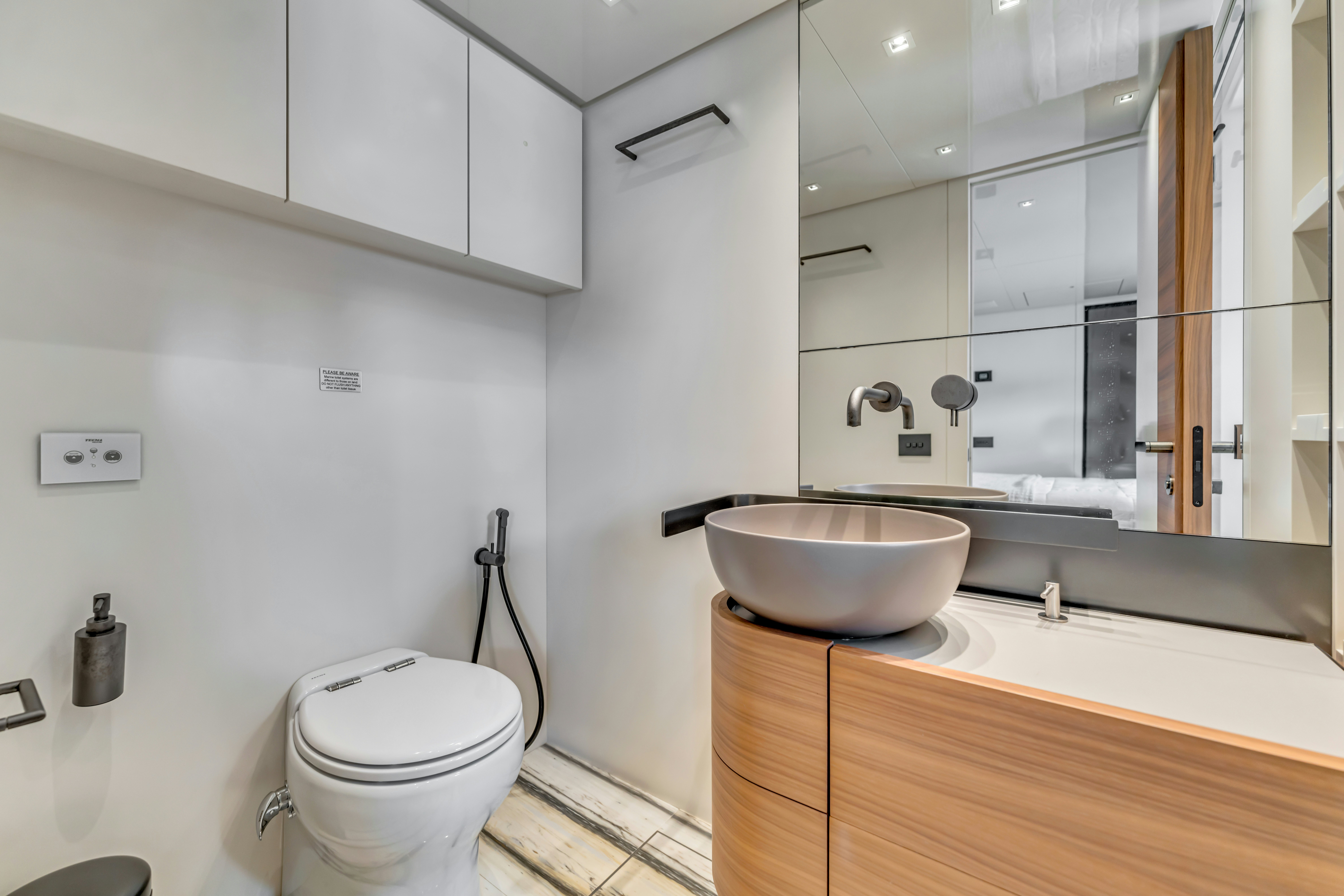 a bathroom with a sink toilet and a bathtub aboard NOTYNOG Yacht for Charter