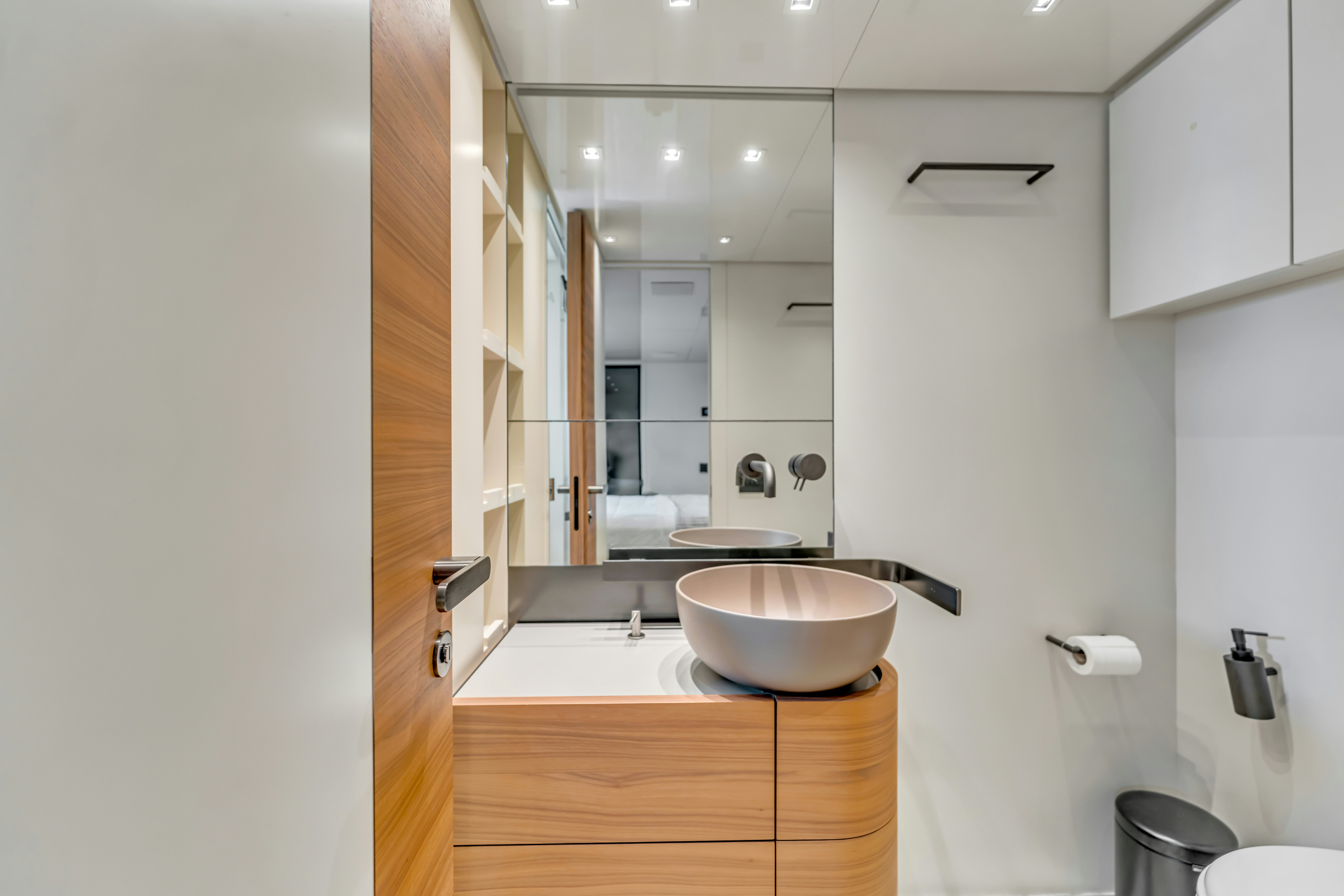 a bathroom with a sink and a mirror aboard NOTYNOG Yacht for Charter