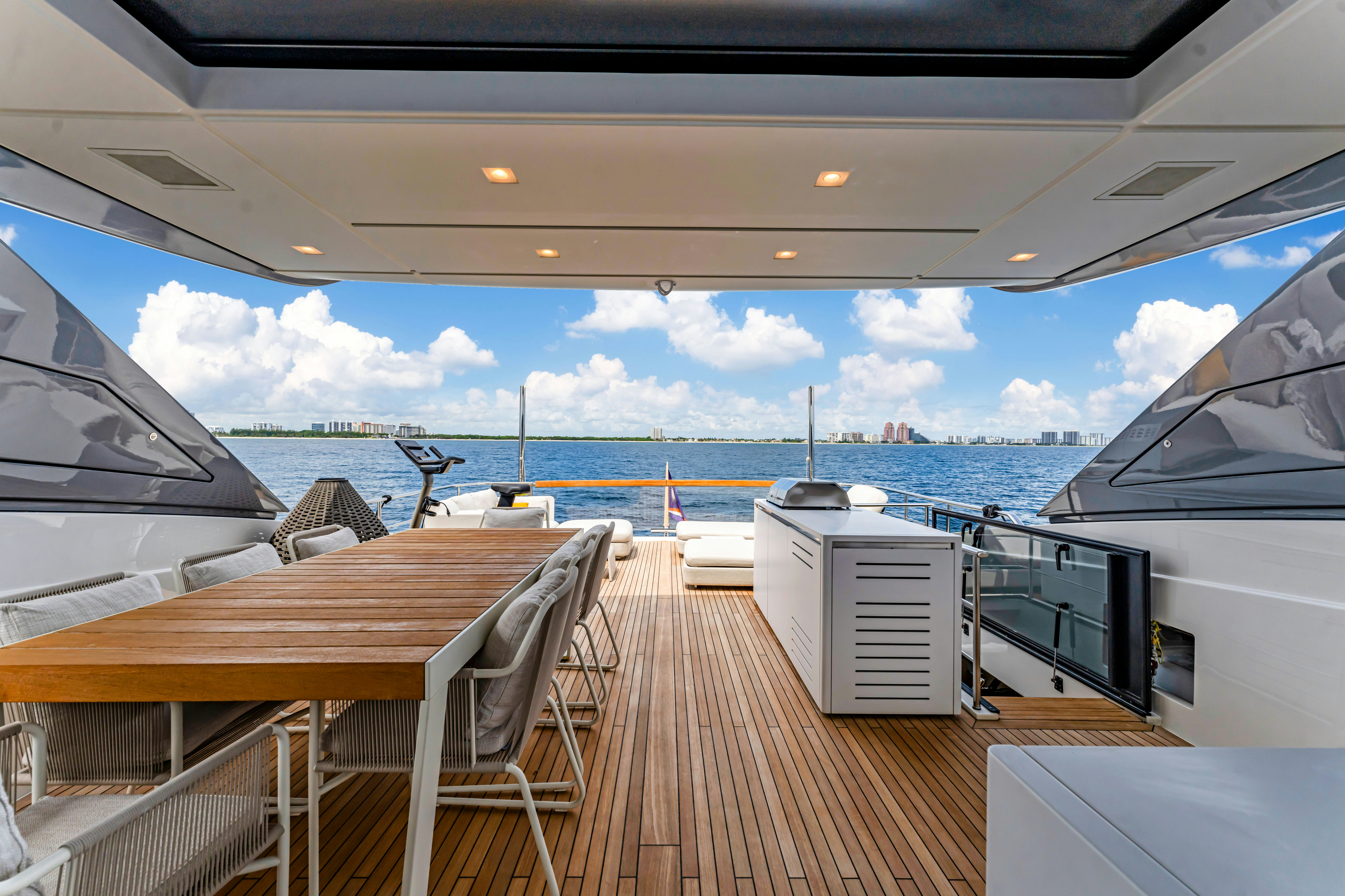 a deck with a view of the water and a city aboard NOTYNOG Yacht for Charter