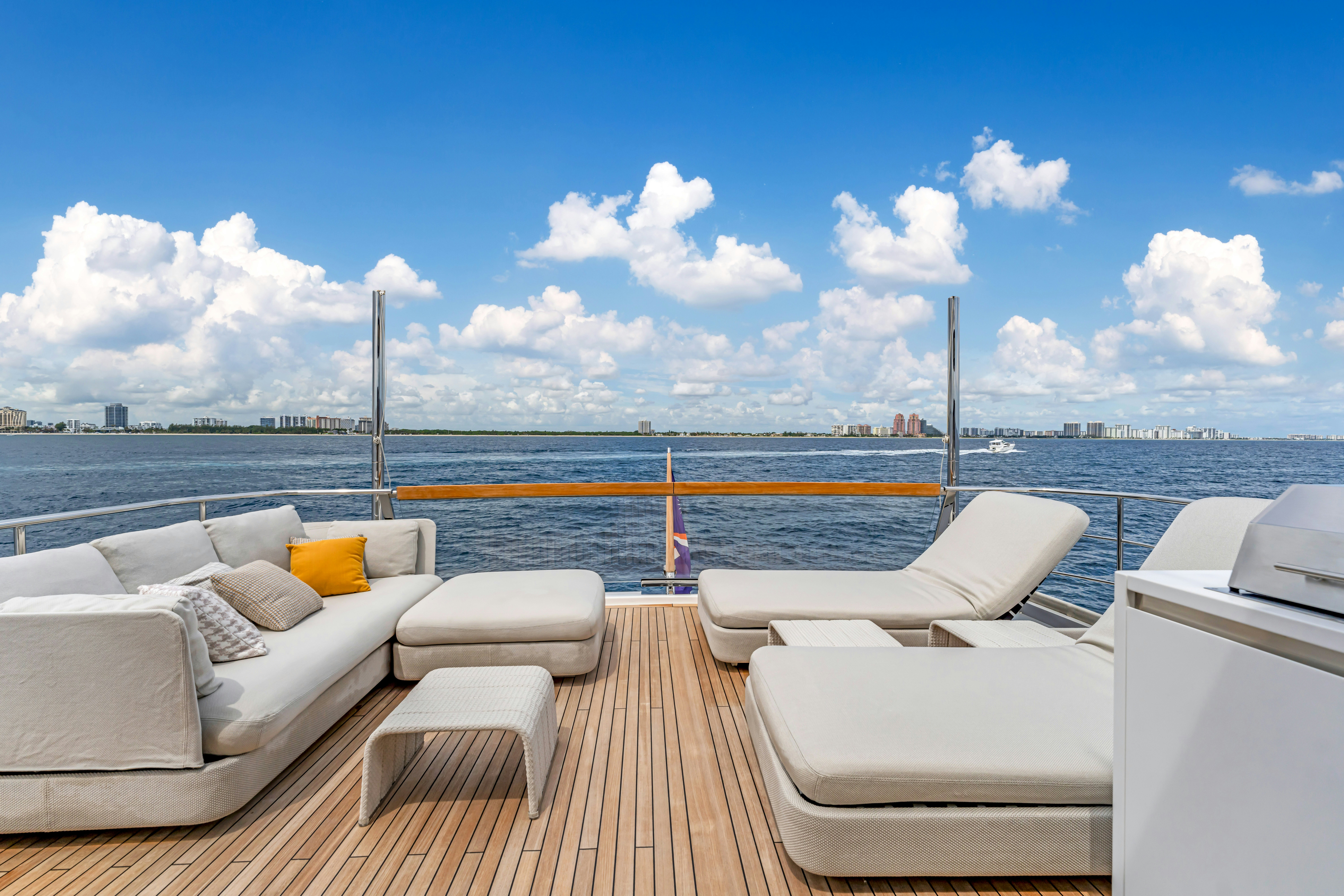 a deck with chairs and a body of water in the background aboard NOTYNOG Yacht for Charter