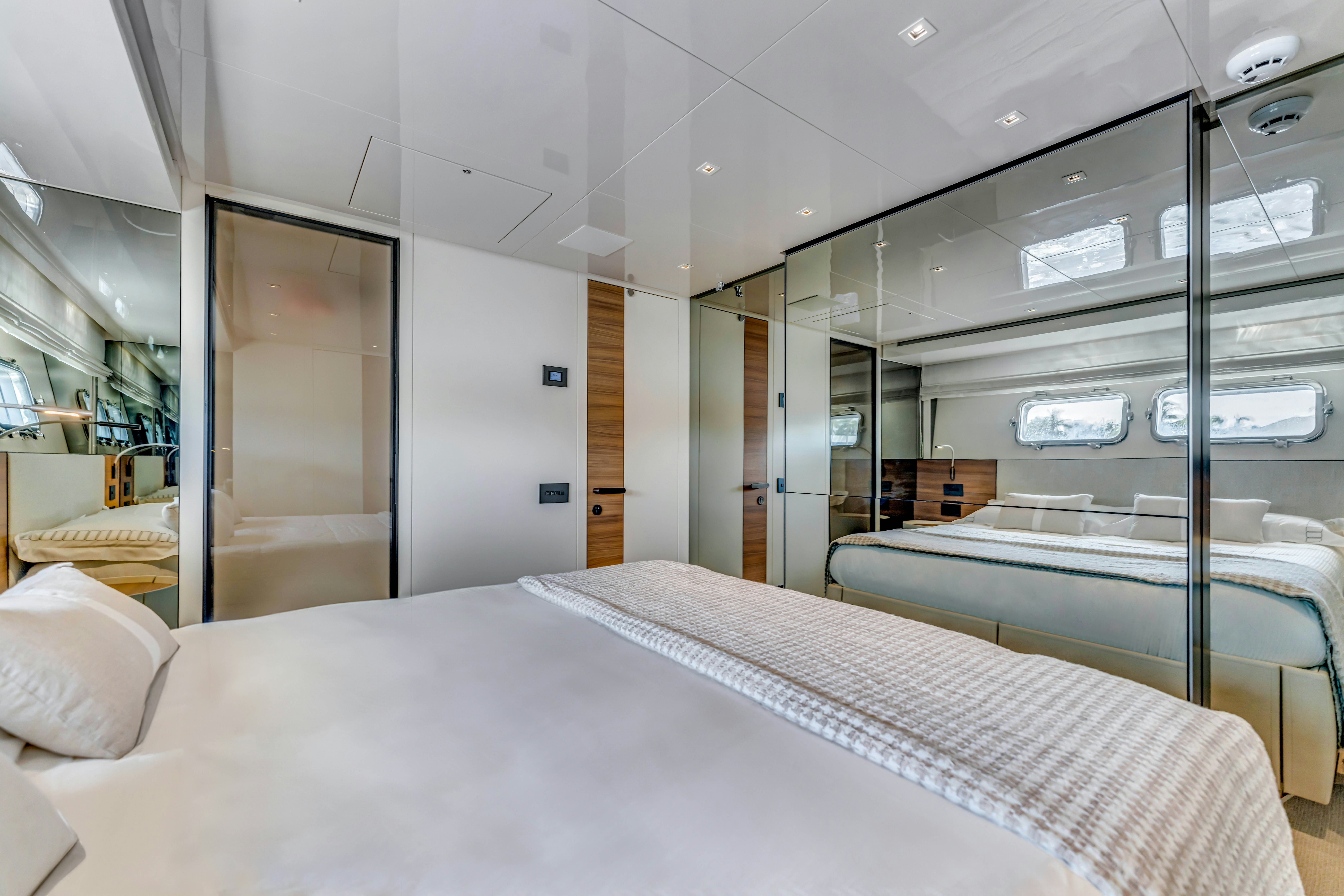 a room with a bed and a window aboard NOTYNOG Yacht for Charter