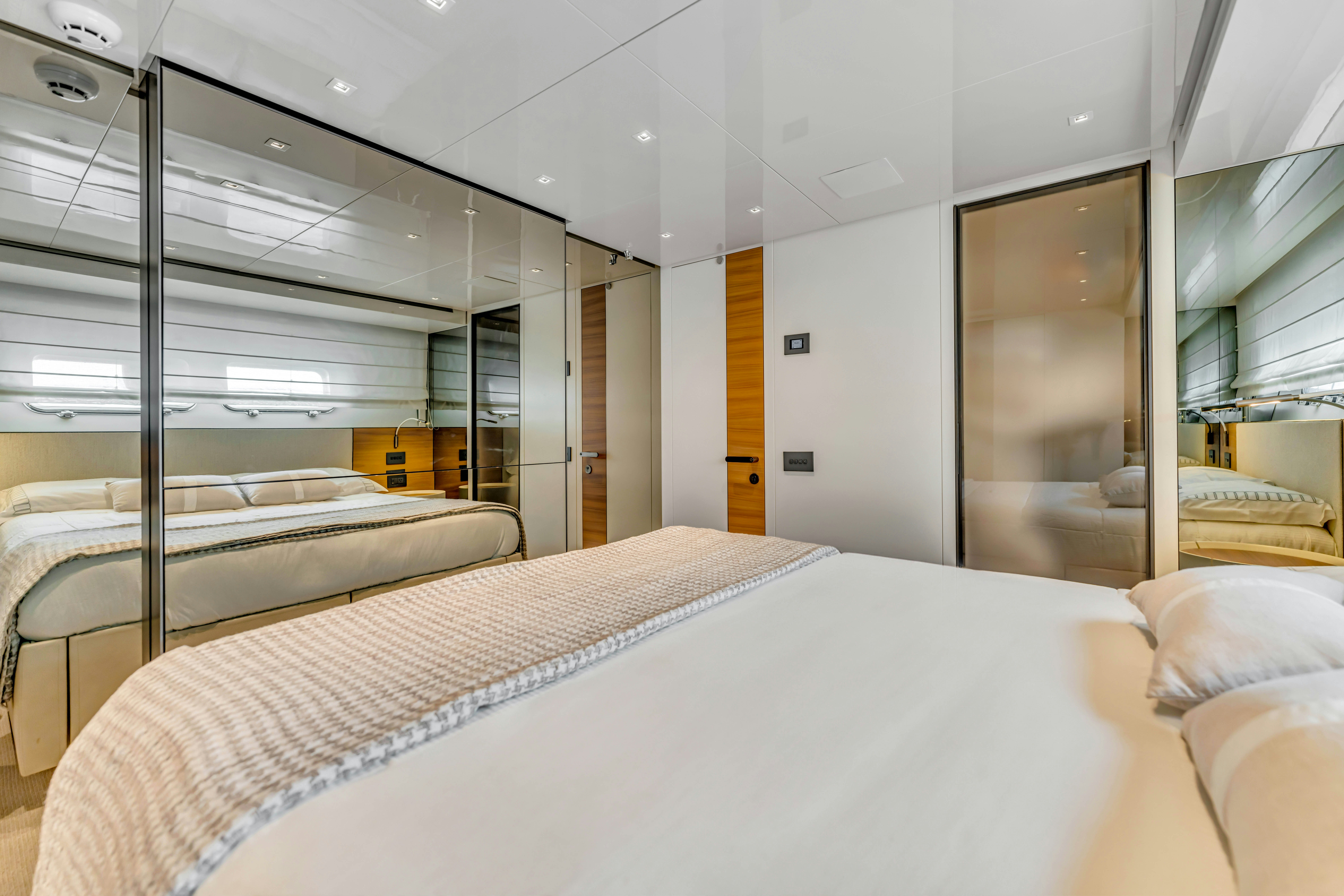 a room with a bed and a window aboard NOTYNOG Yacht for Charter