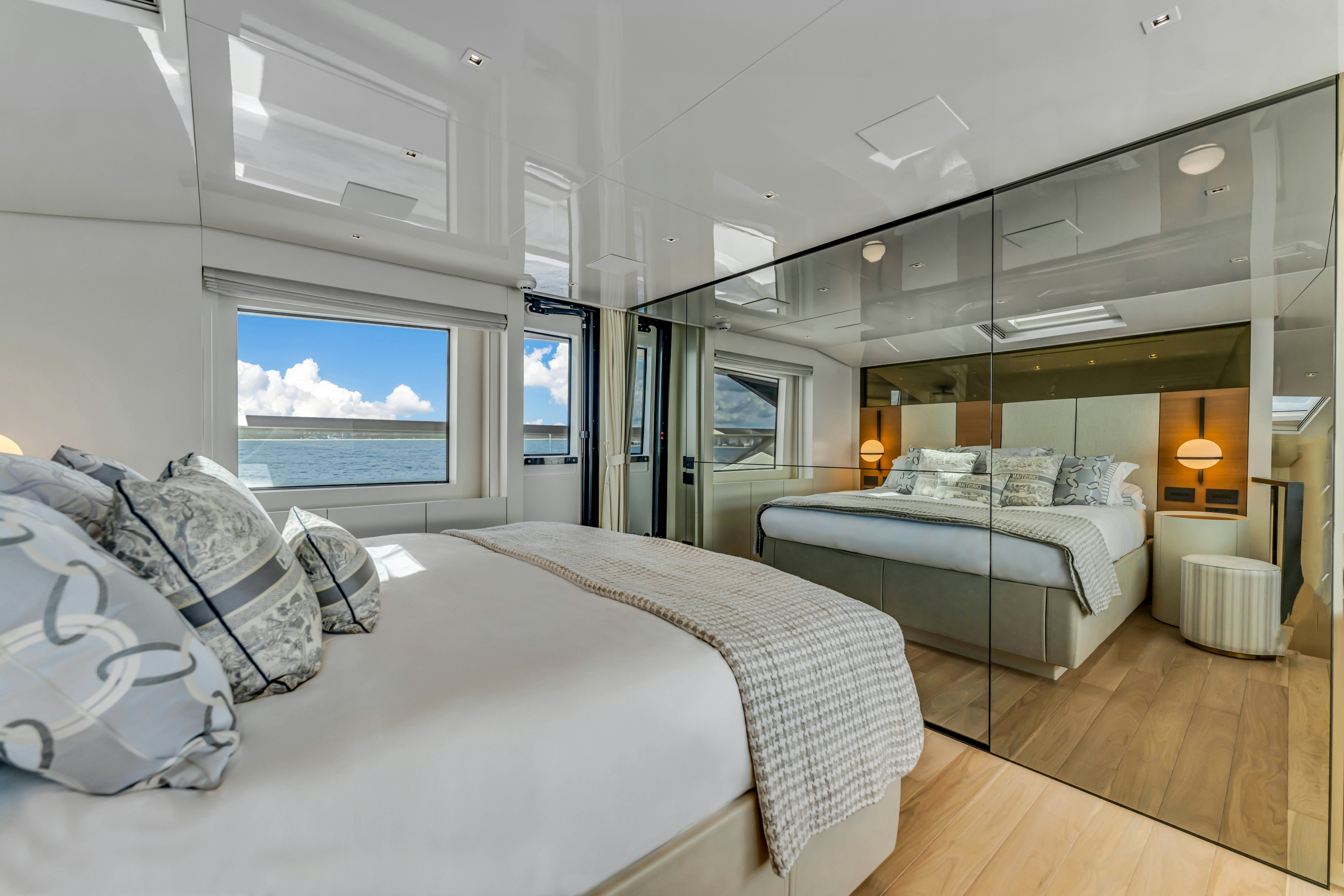 a room with a bed and a large window aboard NOTYNOG Yacht for Charter