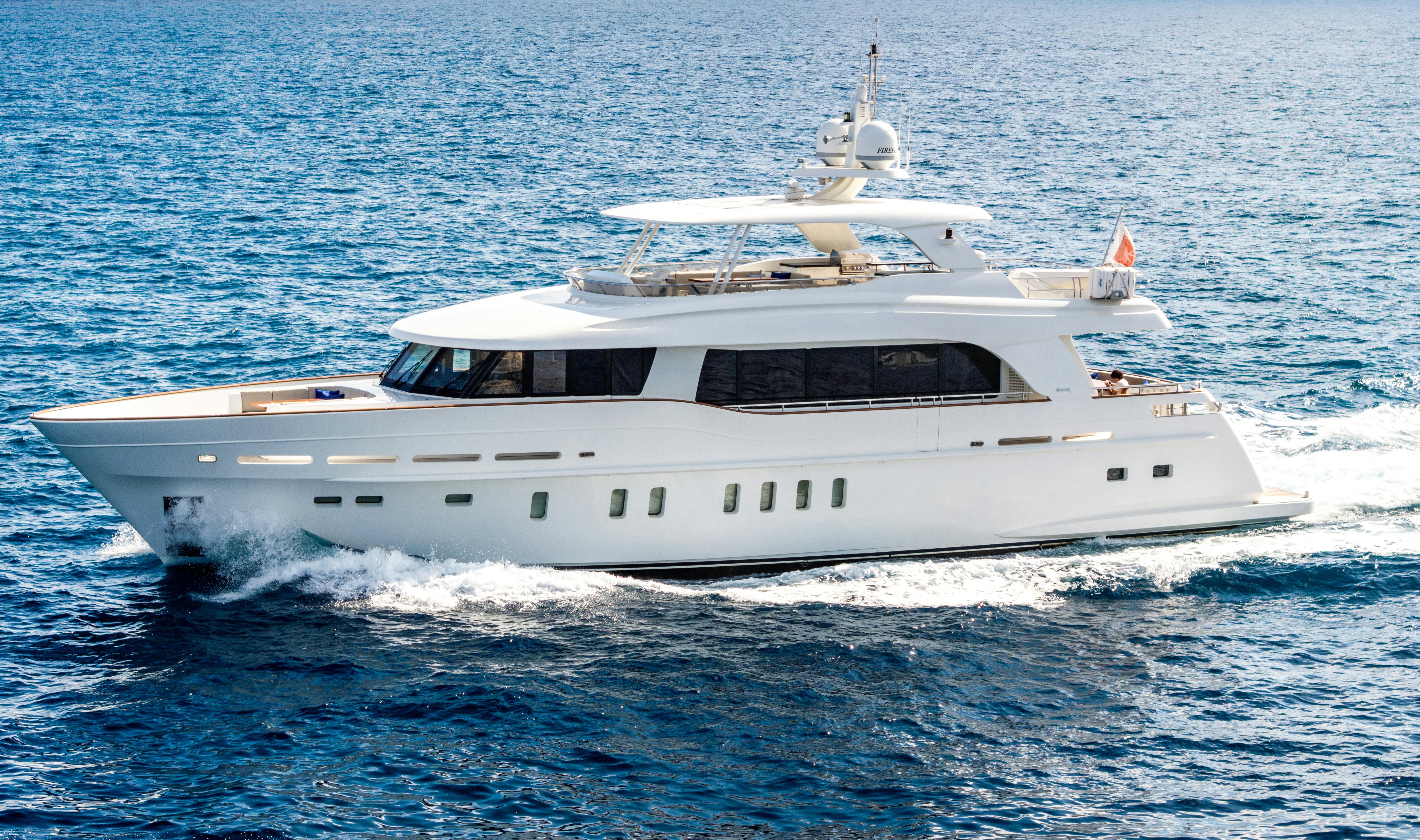 a white yacht on the water aboard FIREFLY Yacht for Sale