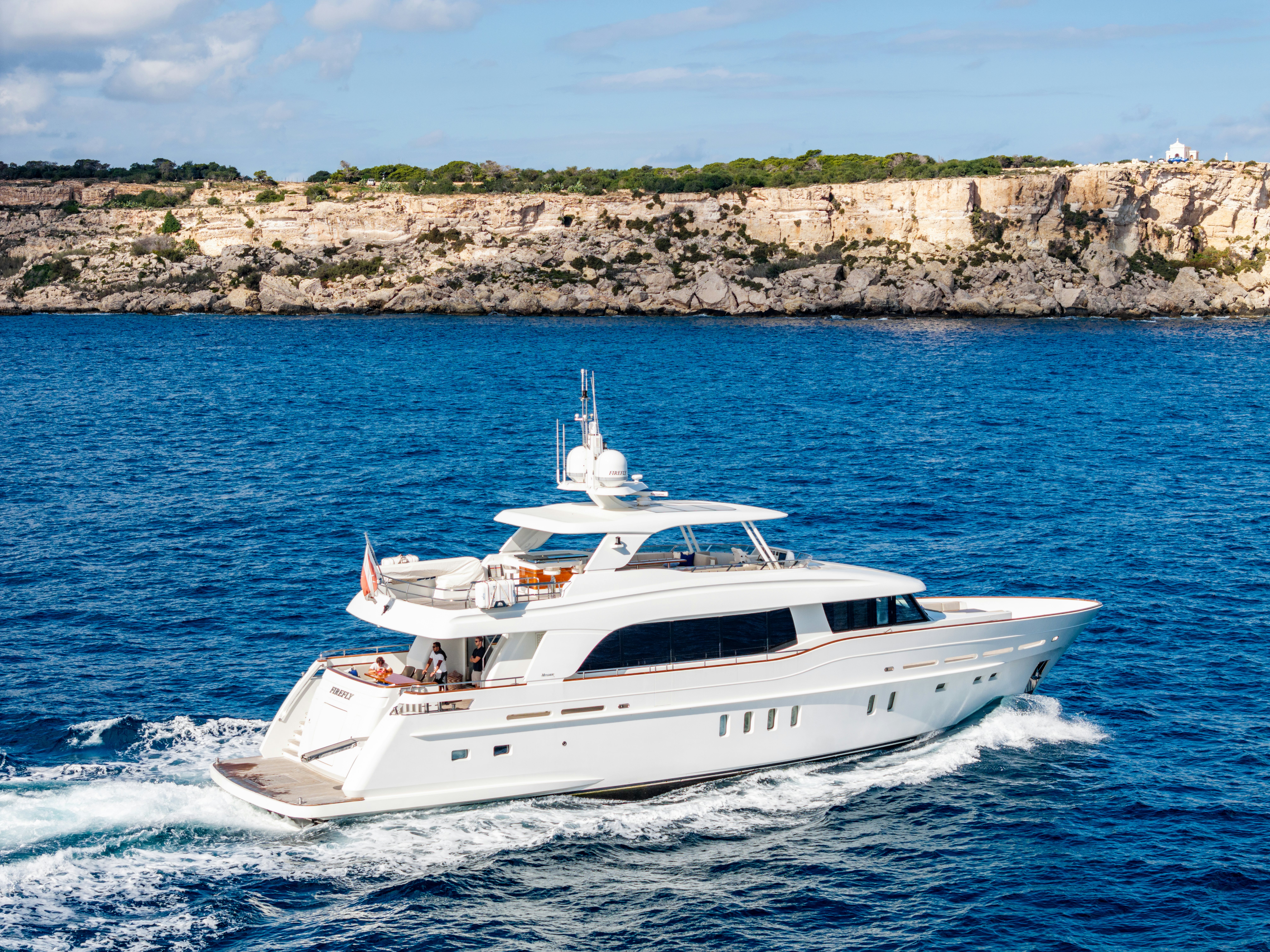 a white yacht on the water aboard FIREFLY Yacht for Sale