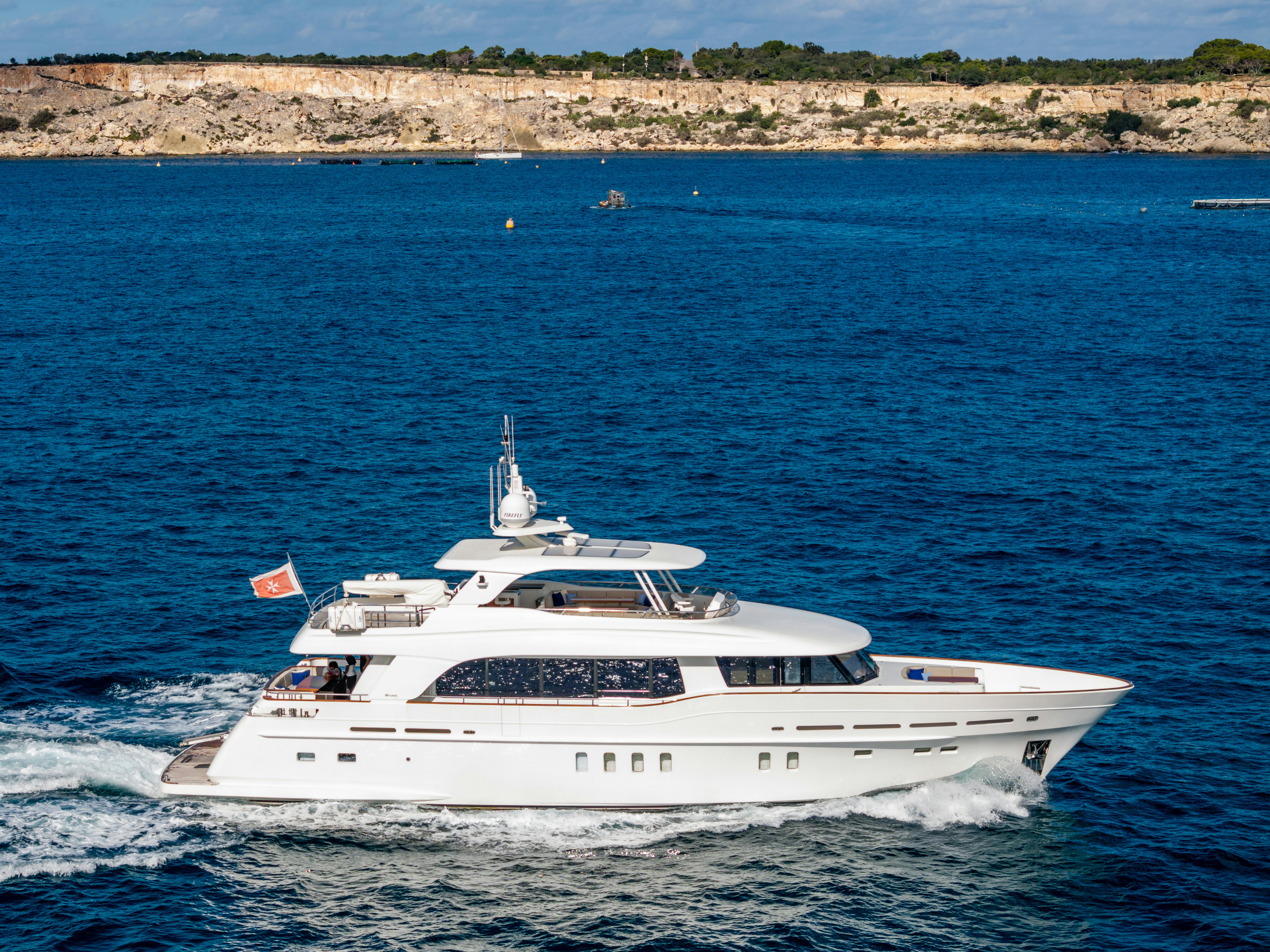 a white boat on the water aboard FIREFLY Yacht for Sale