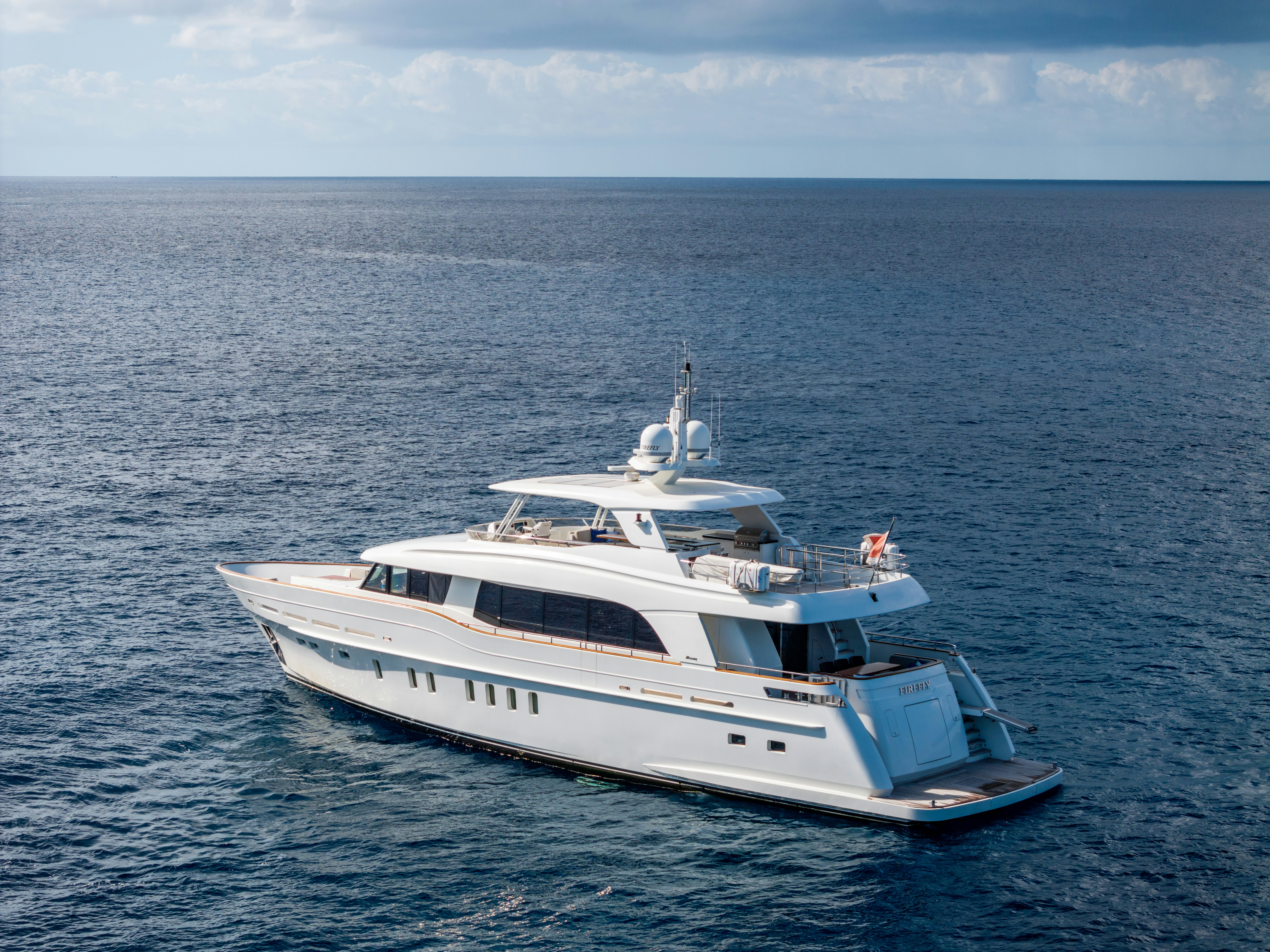 a white yacht in the water aboard FIREFLY Yacht for Sale