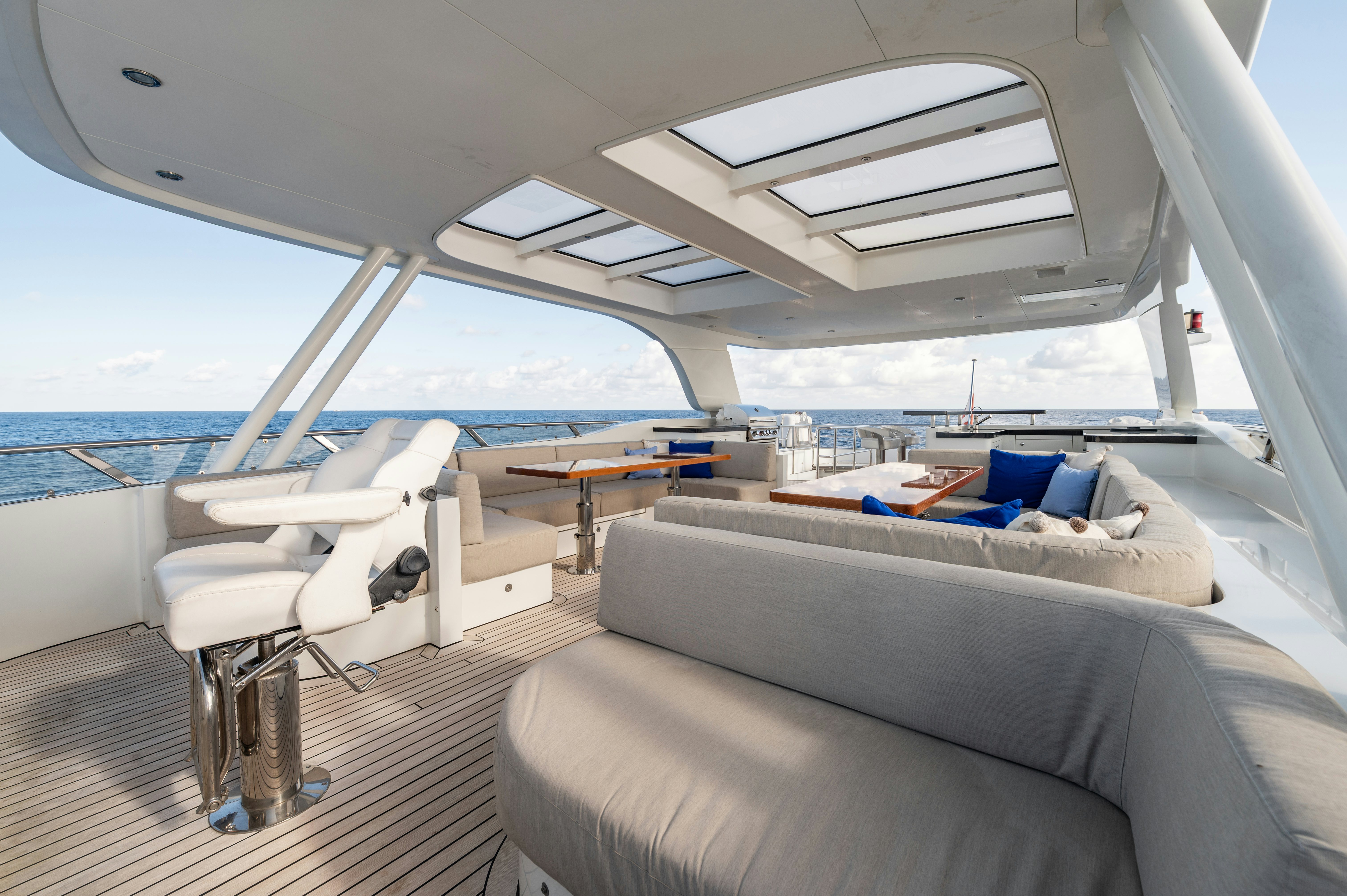 a boat with a couch and a table and a chair aboard FIREFLY Yacht for Sale