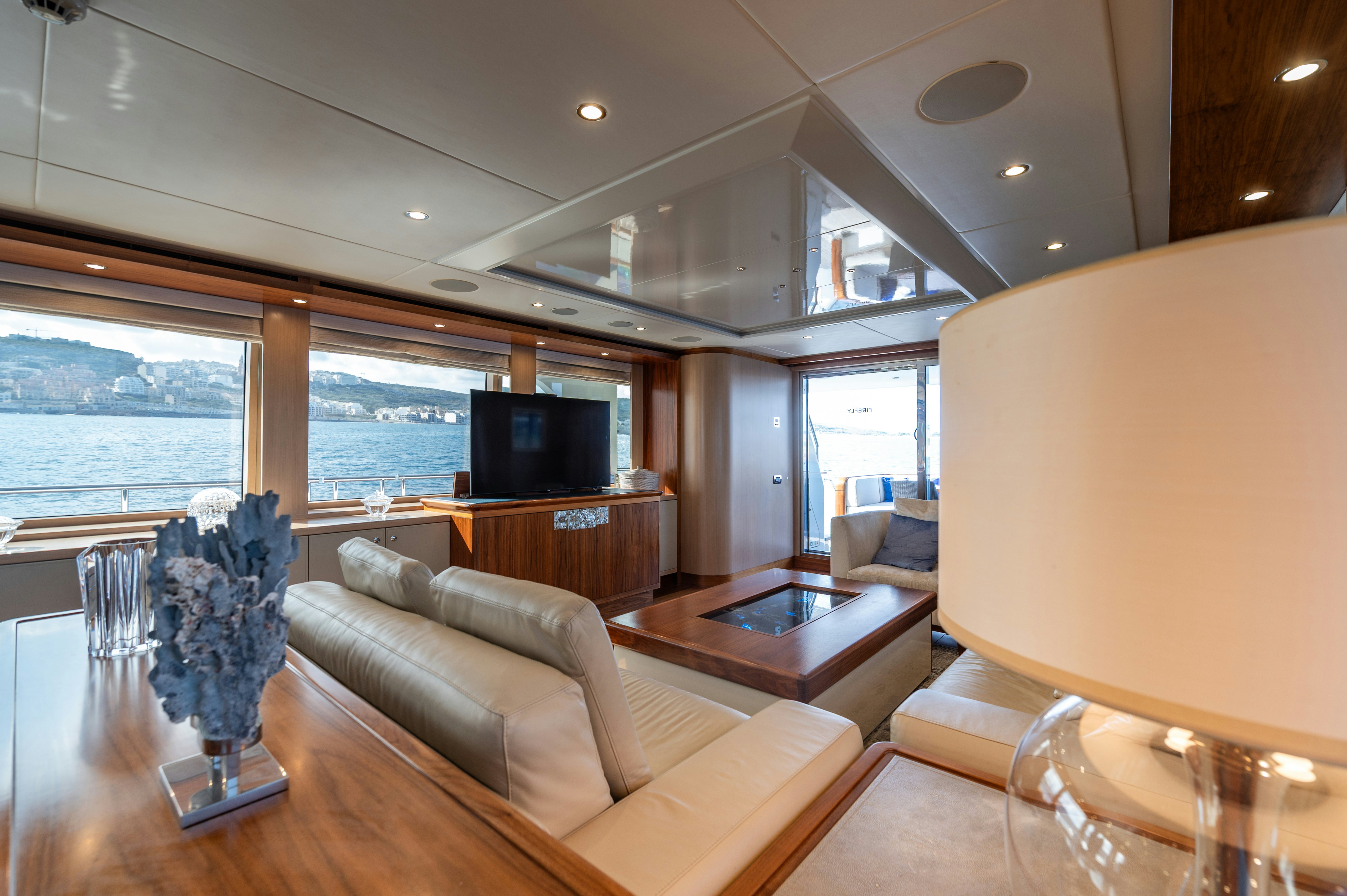 a living room with a large window aboard FIREFLY Yacht for Sale