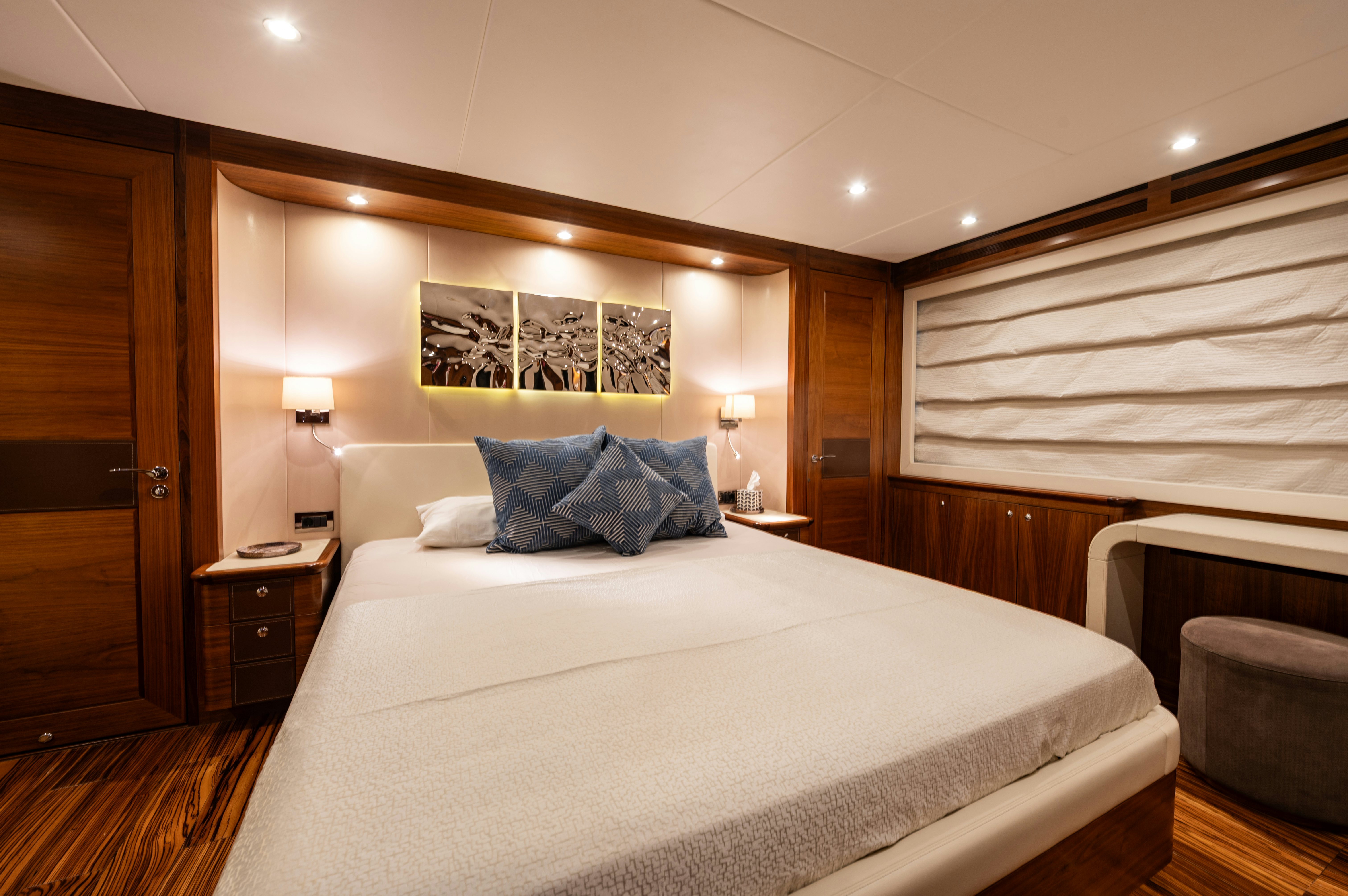 a bed with a white sheet and pillows in a hotel room aboard FIREFLY Yacht for Sale