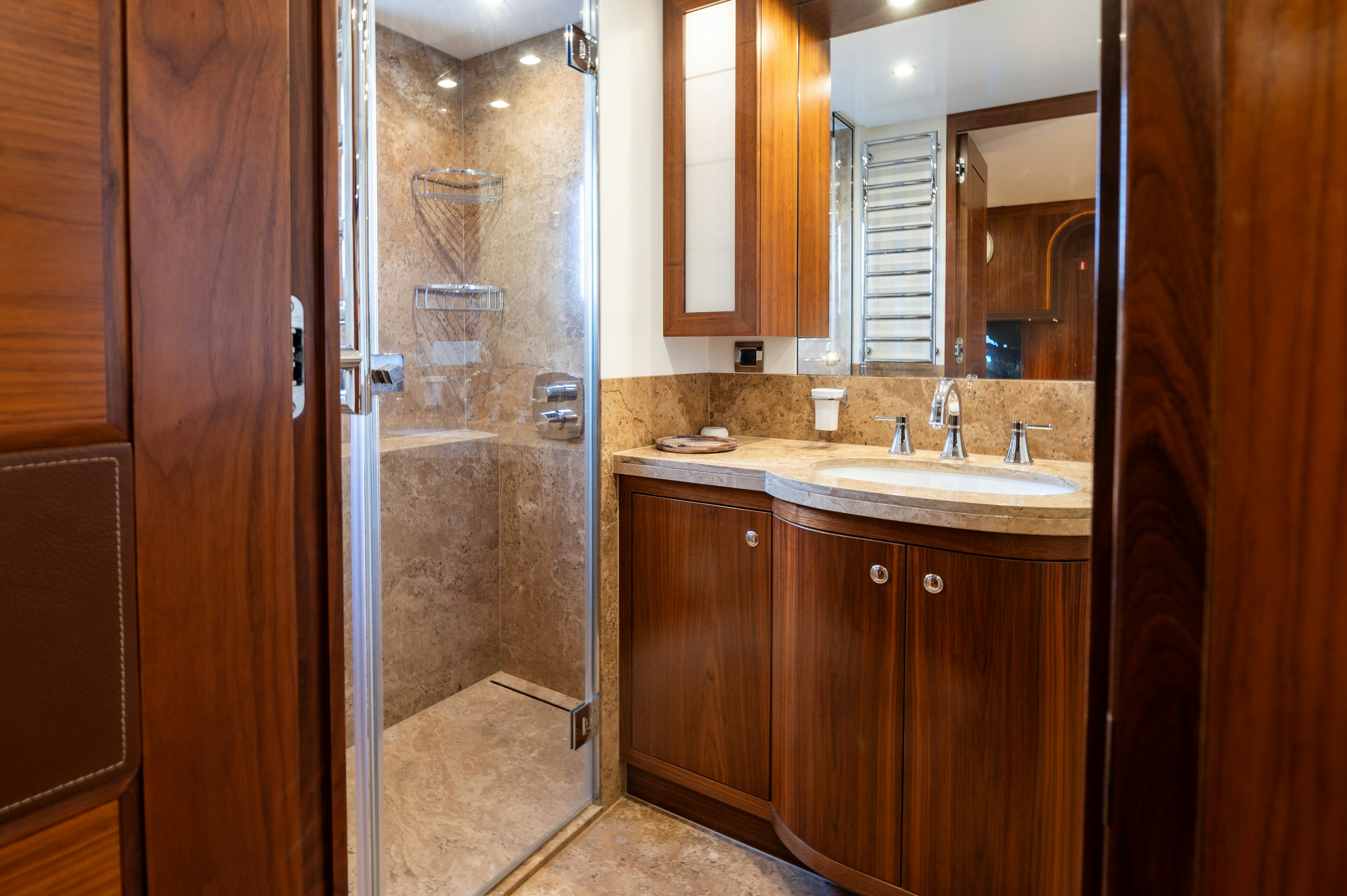 a bathroom with a shower unit and sink aboard FIREFLY Yacht for Sale