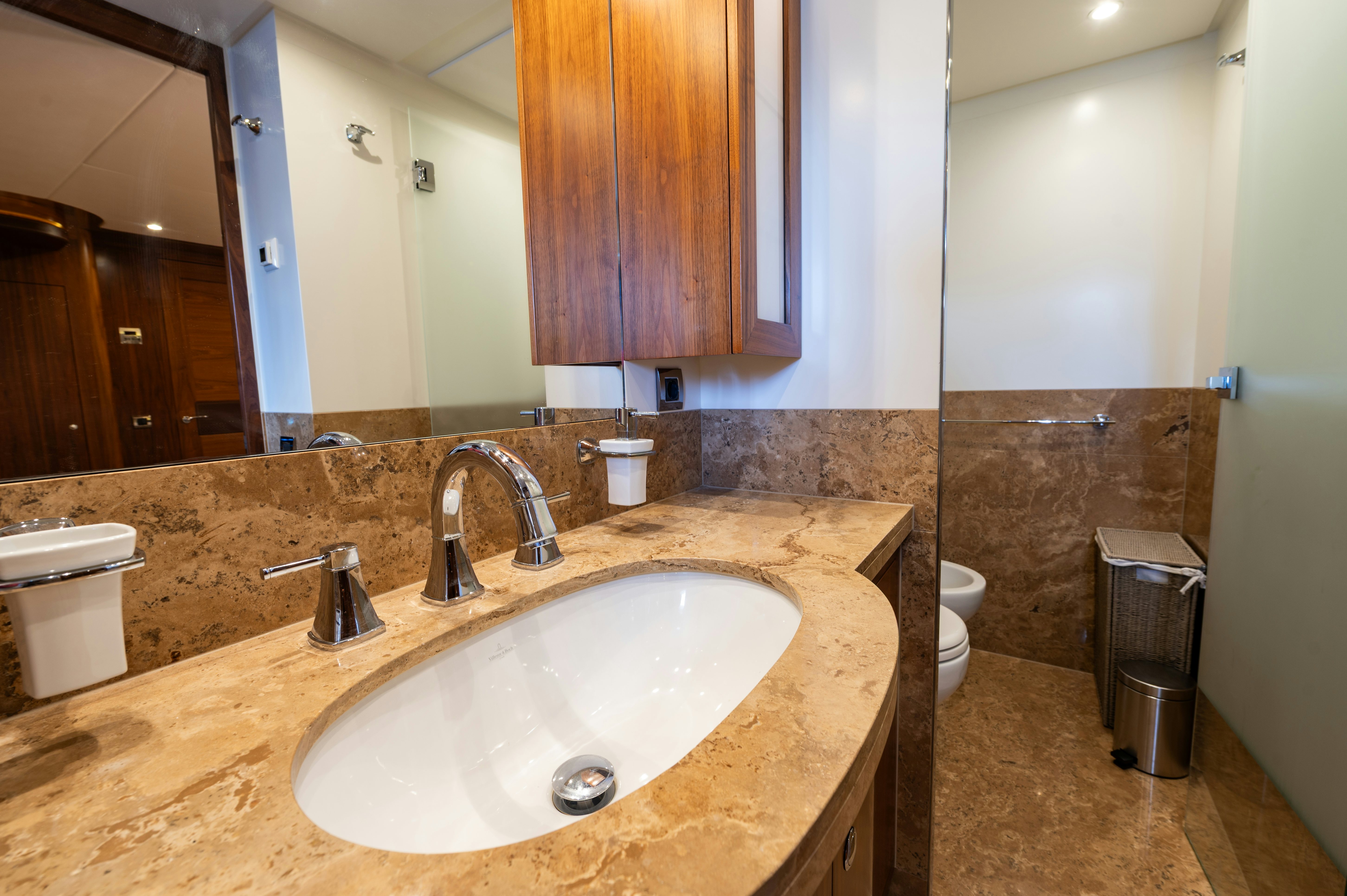 a bathroom with a sink and a mirror aboard FIREFLY Yacht for Sale