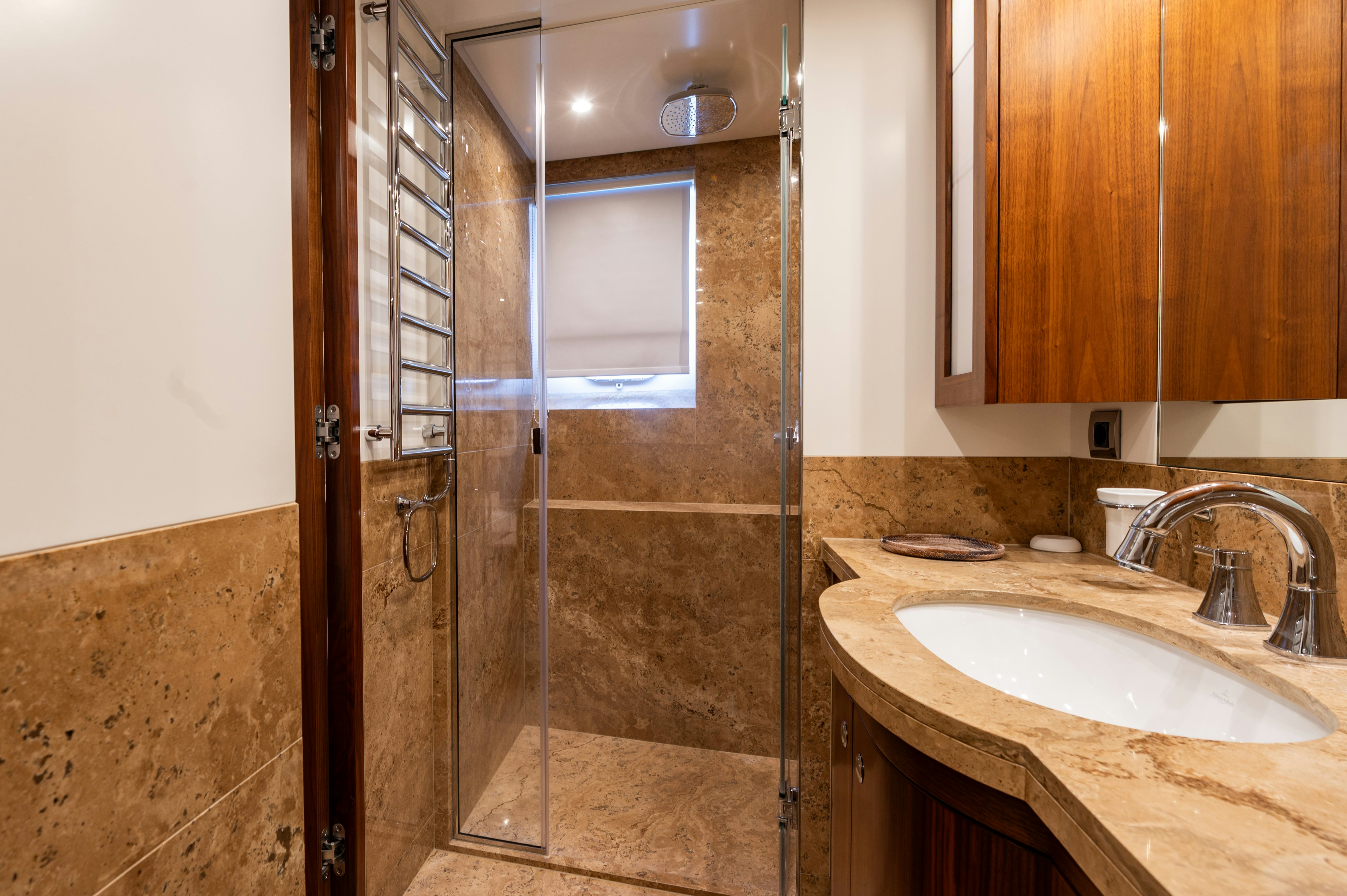 a bathroom with a glass shower aboard FIREFLY Yacht for Sale