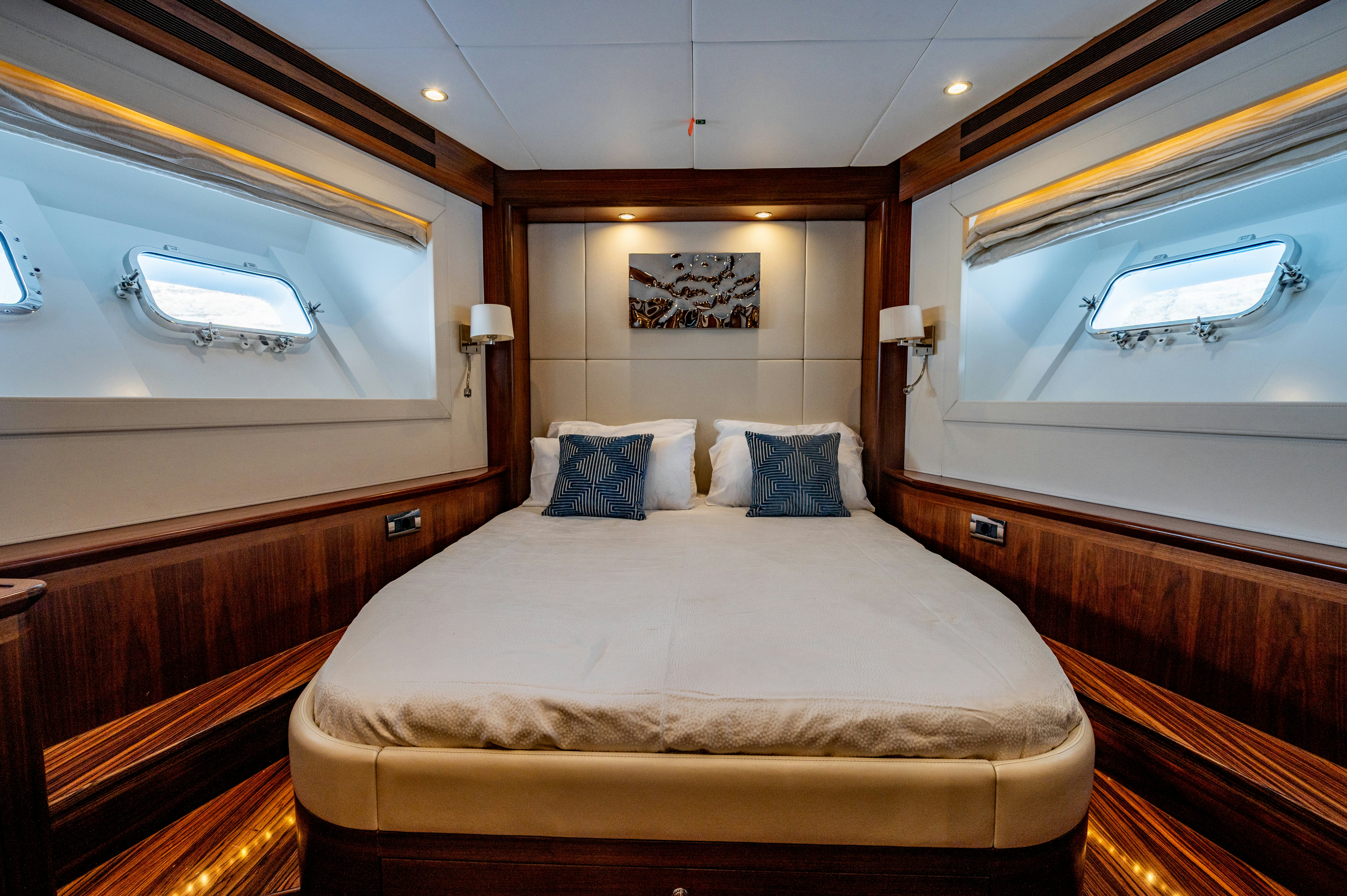 a room with a bed and a window aboard FIREFLY Yacht for Sale