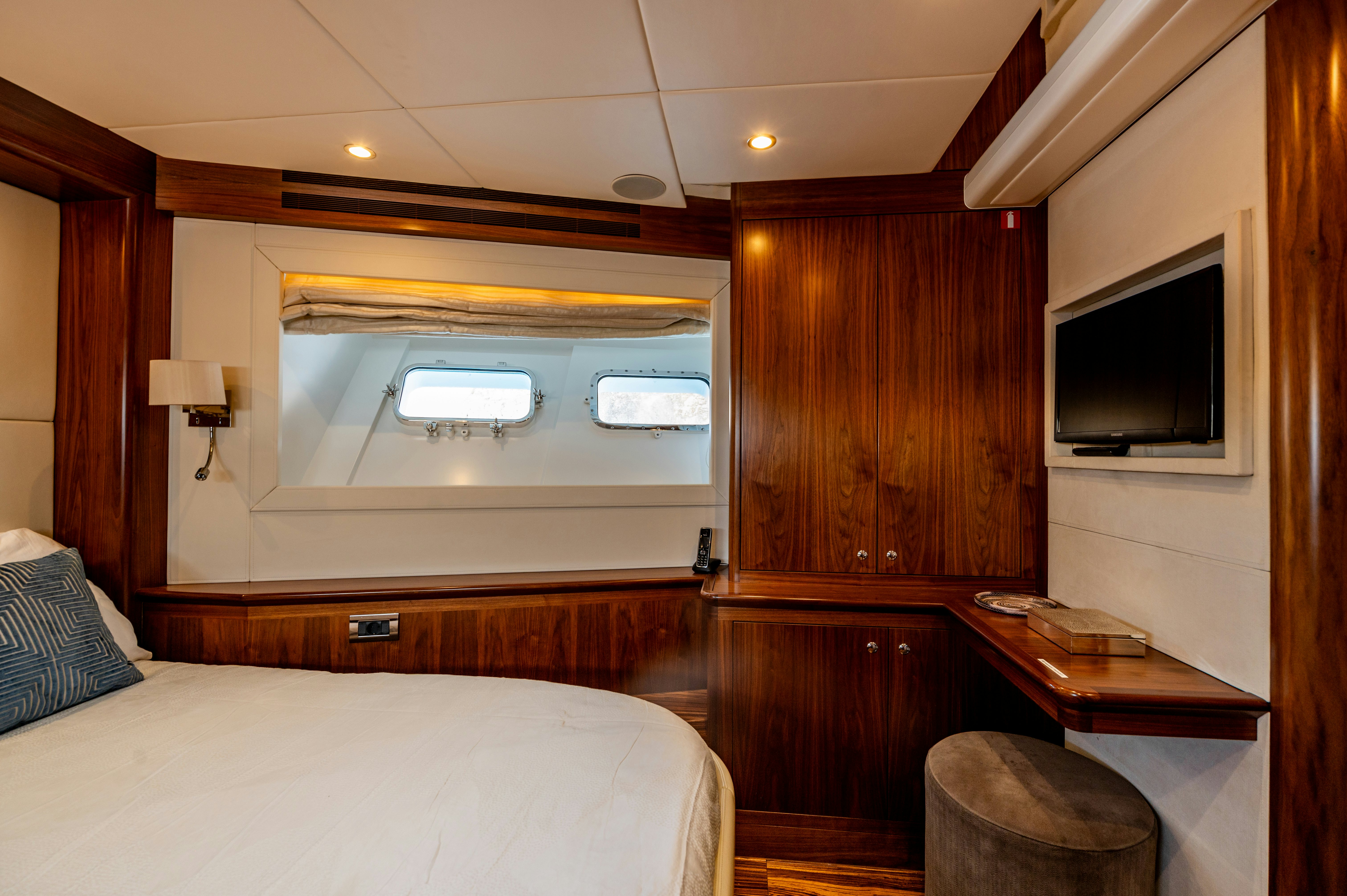 a room with a bed and a television aboard FIREFLY Yacht for Sale