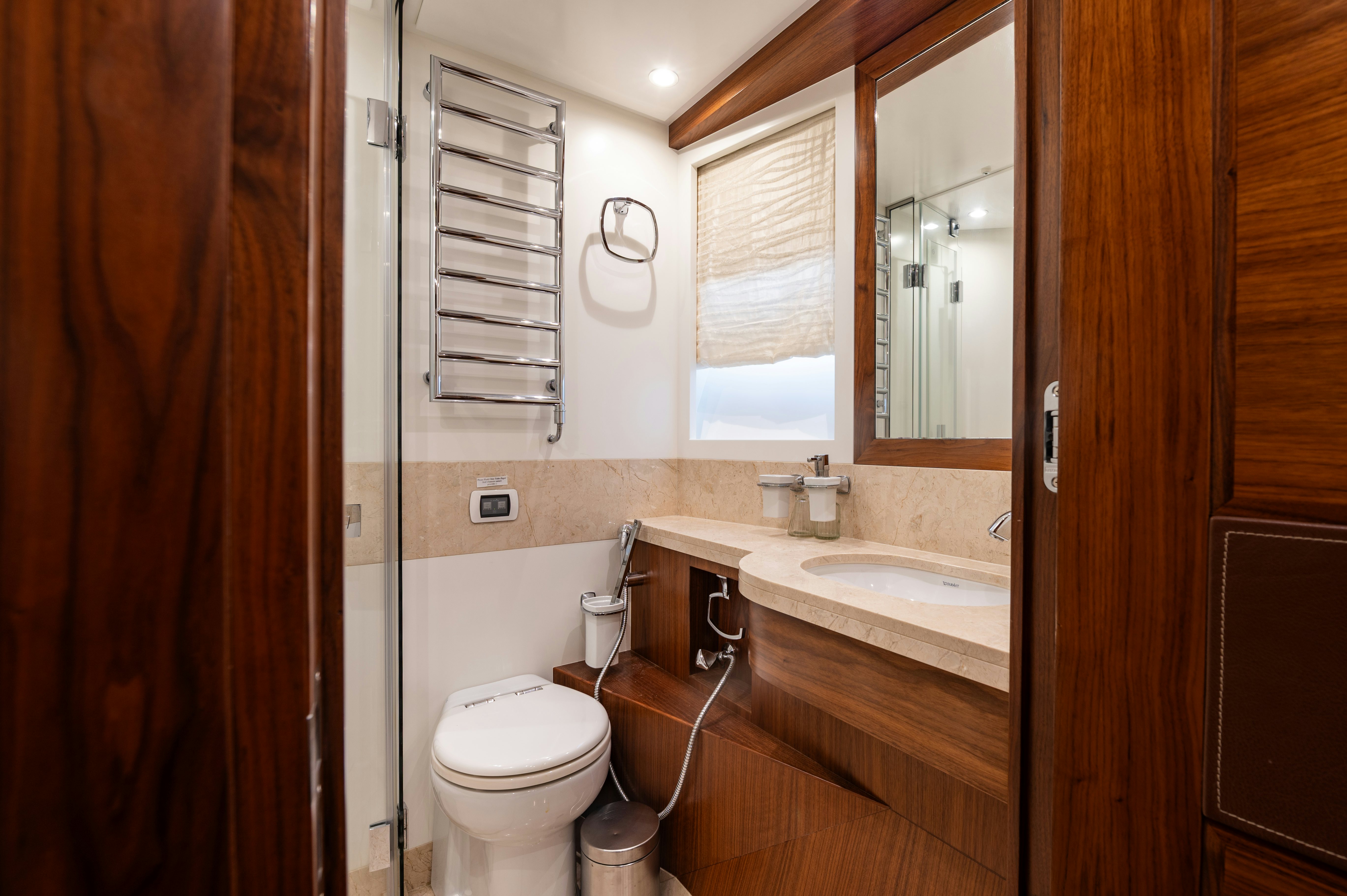 a bathroom with a toilet and a sink aboard FIREFLY Yacht for Sale