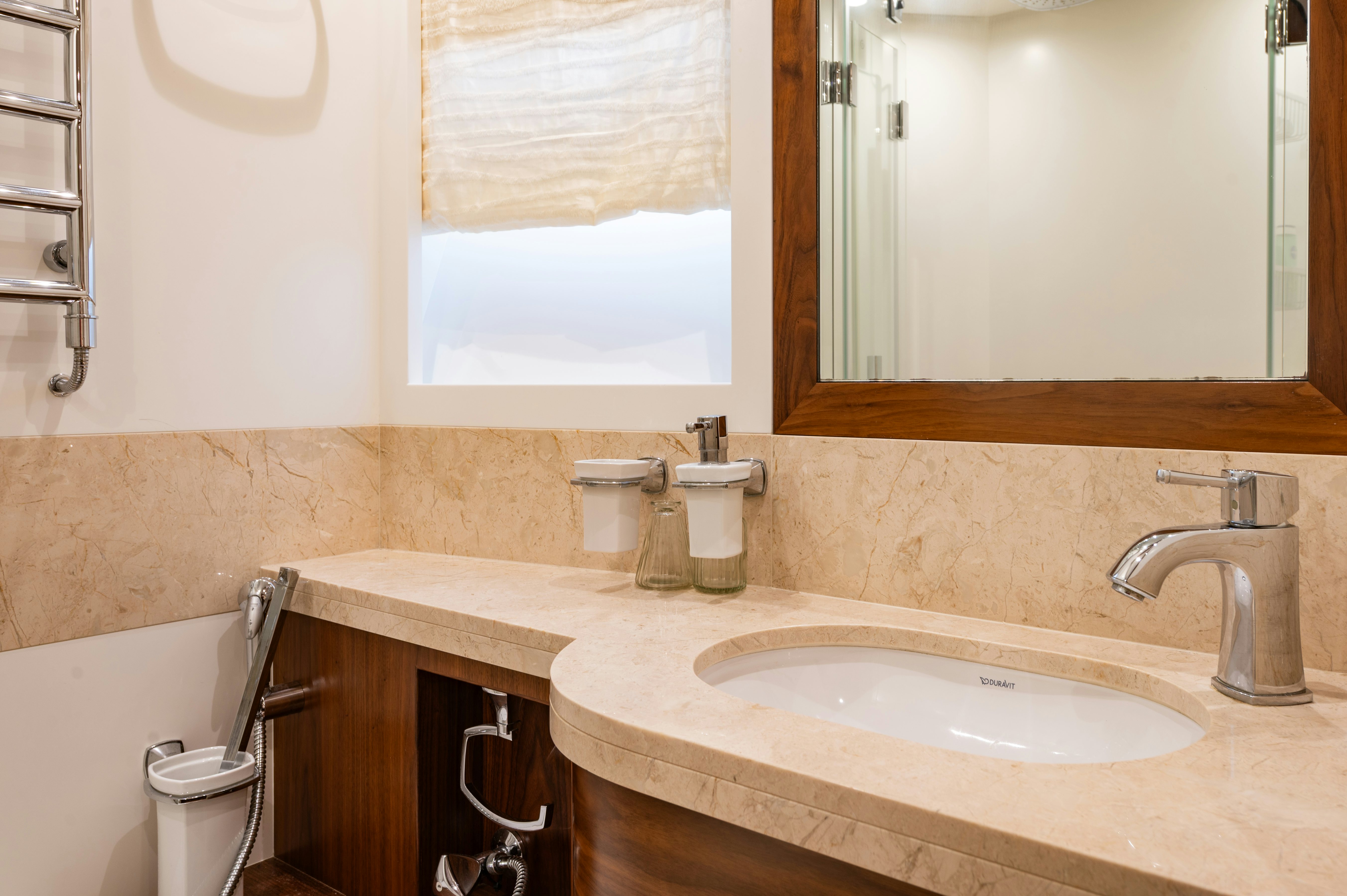 a bathroom with a sink and a mirror aboard FIREFLY Yacht for Sale