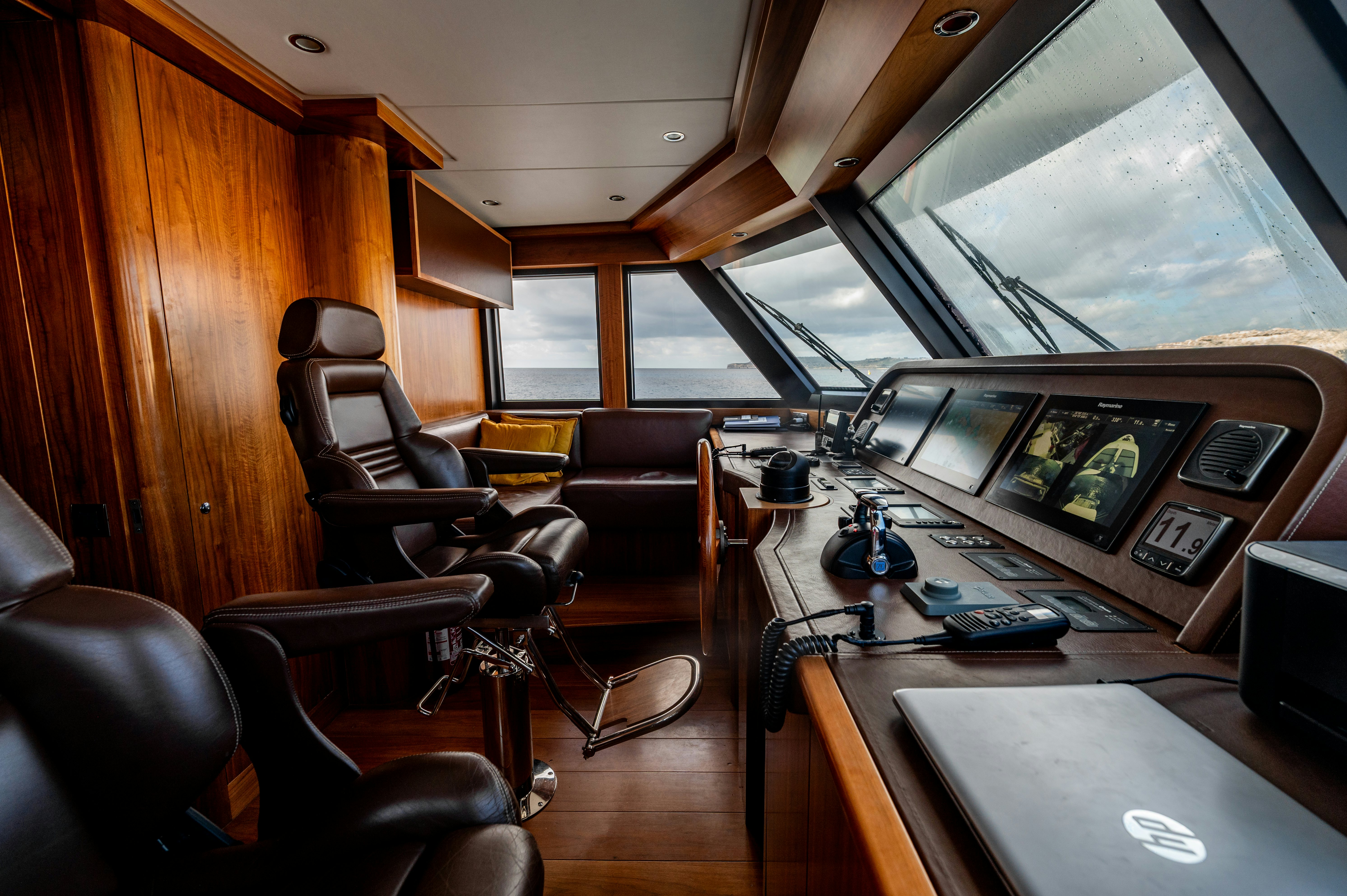 a room with a desk and chairs aboard FIREFLY Yacht for Sale