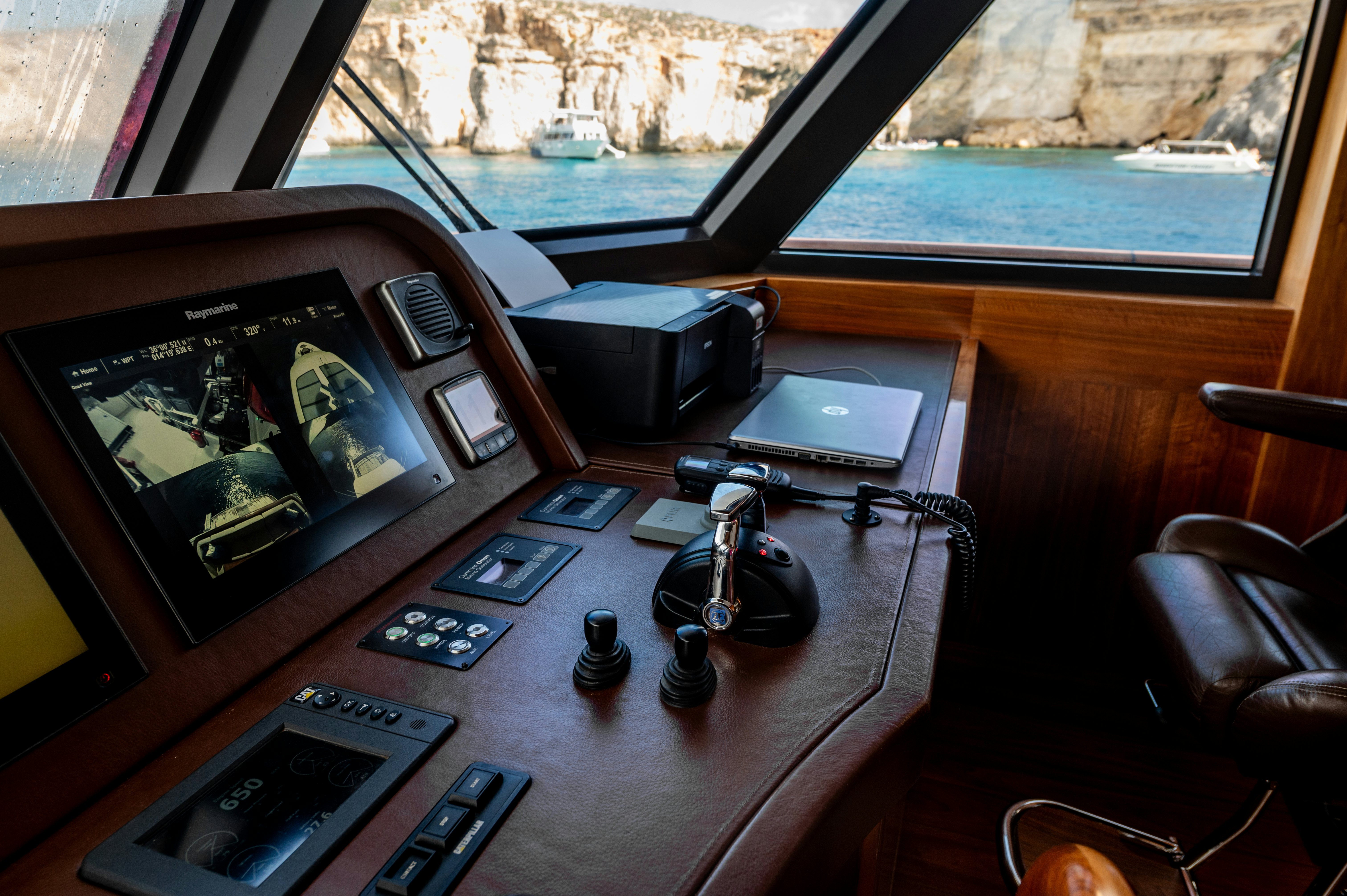 a table with electronics and a television aboard FIREFLY Yacht for Sale