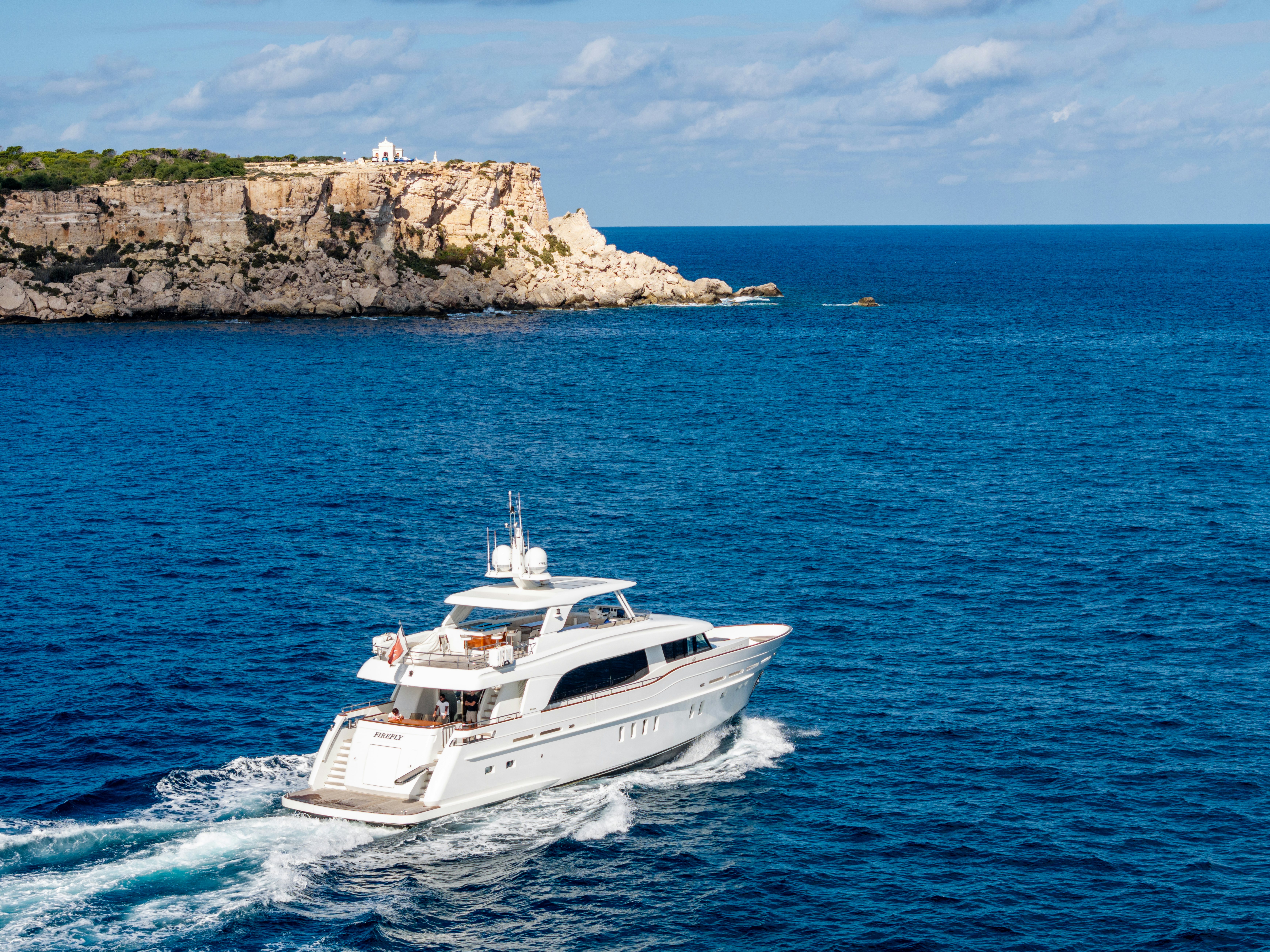 a white boat on the water aboard FIREFLY Yacht for Sale