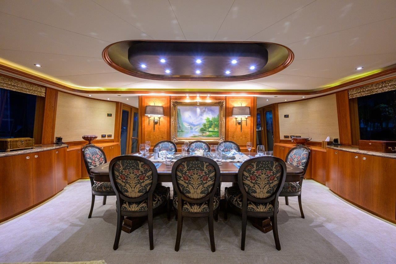 a room with a table and chairs aboard EXODUS Yacht for Sale