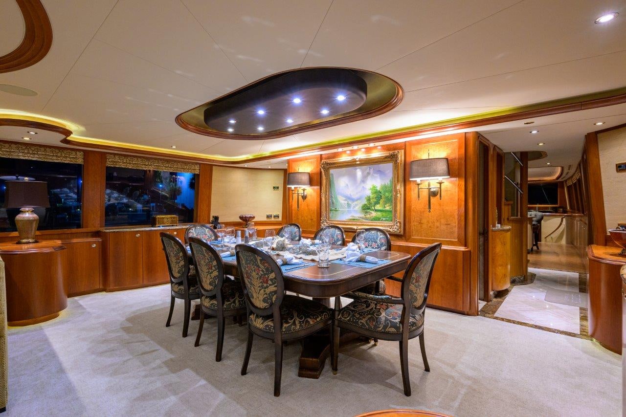 a large dining room with a table and chairs aboard EXODUS Yacht for Sale
