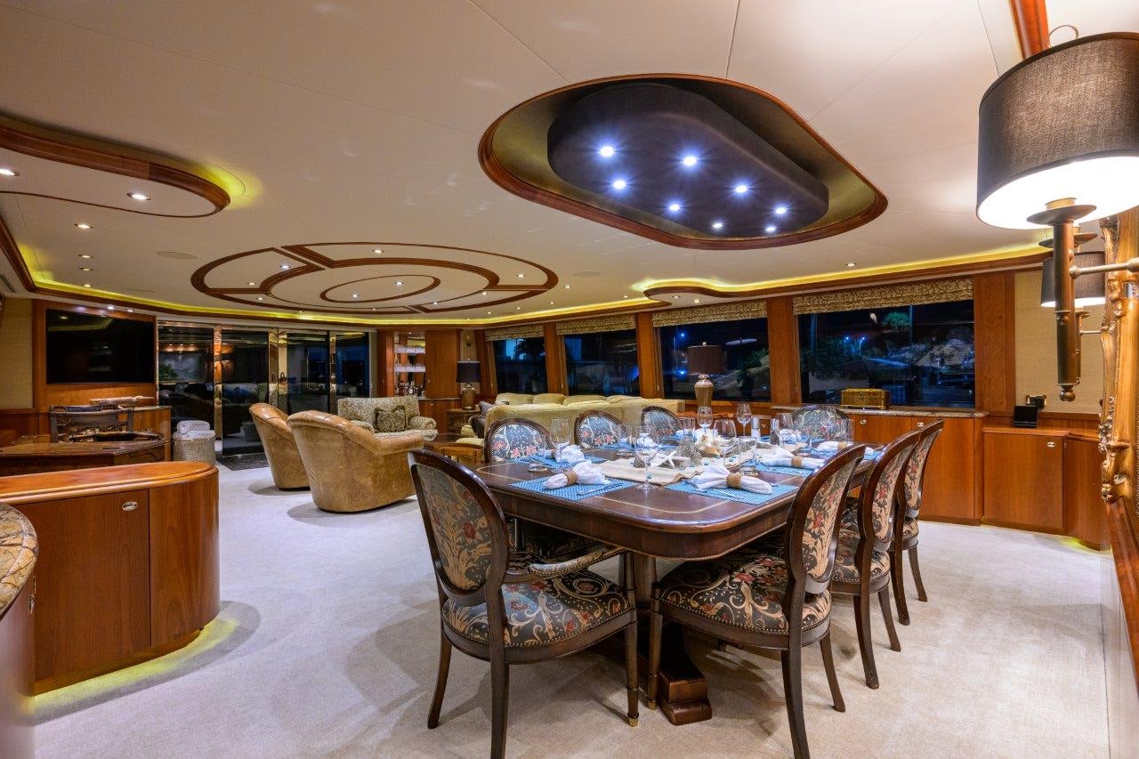 a dining room with a table and chairs aboard EXODUS Yacht for Sale