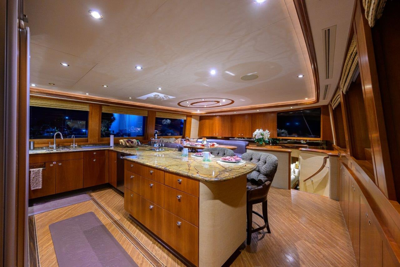 a kitchen with wooden cabinets aboard EXODUS Yacht for Sale