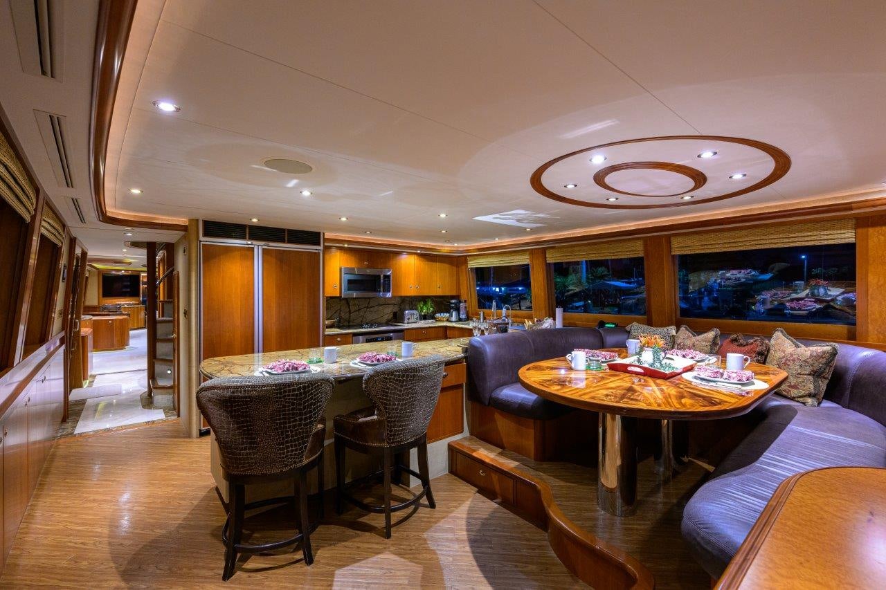 a living room with a dining table aboard EXODUS Yacht for Sale