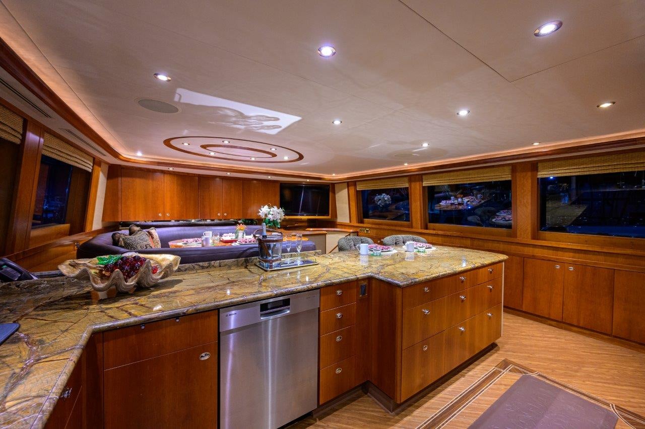 a kitchen with wooden cabinets aboard EXODUS Yacht for Sale