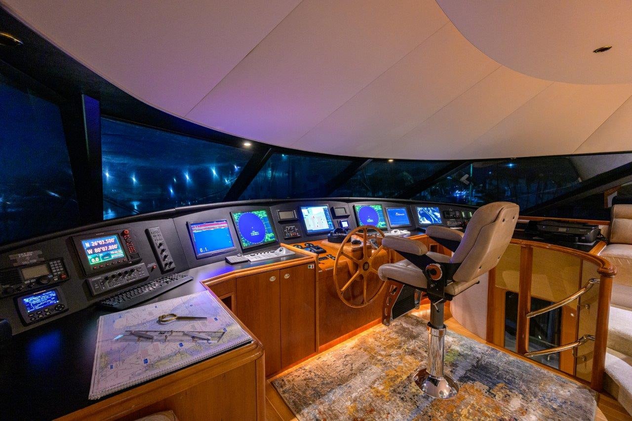 a room with a desk and chairs aboard EXODUS Yacht for Sale