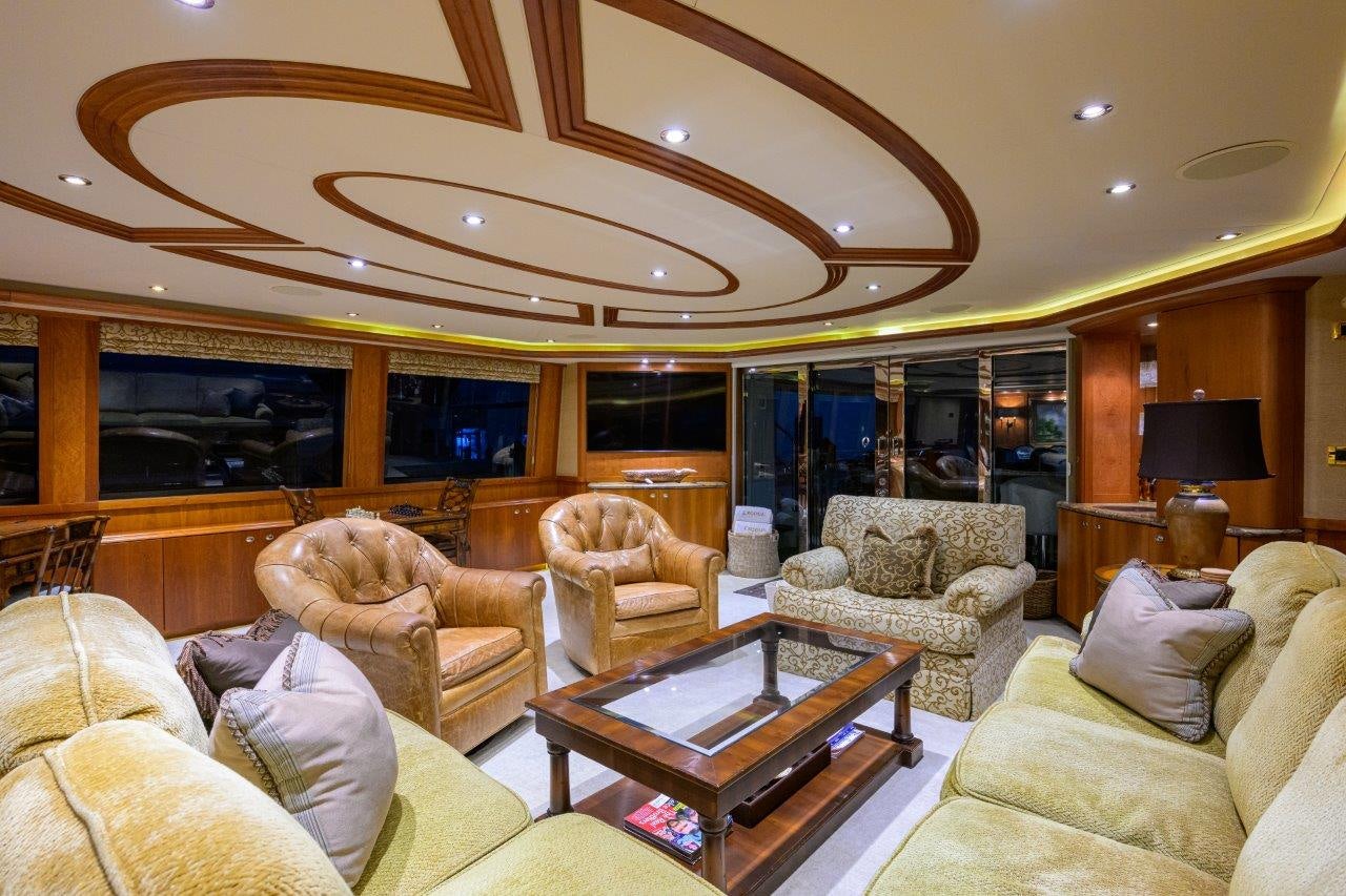 a living room with a fireplace aboard EXODUS Yacht for Sale