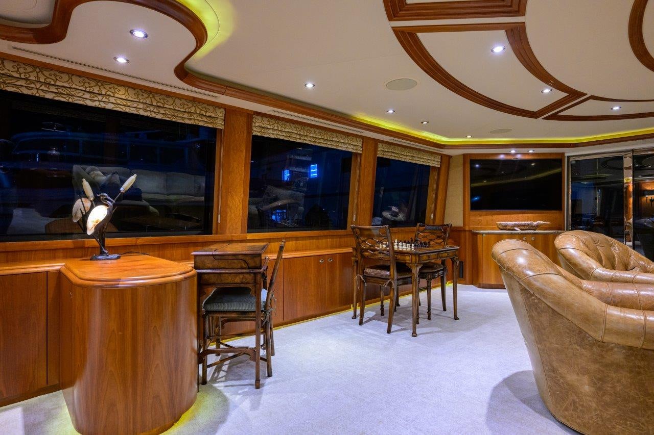 a large room with a table and chairs aboard EXODUS Yacht for Sale