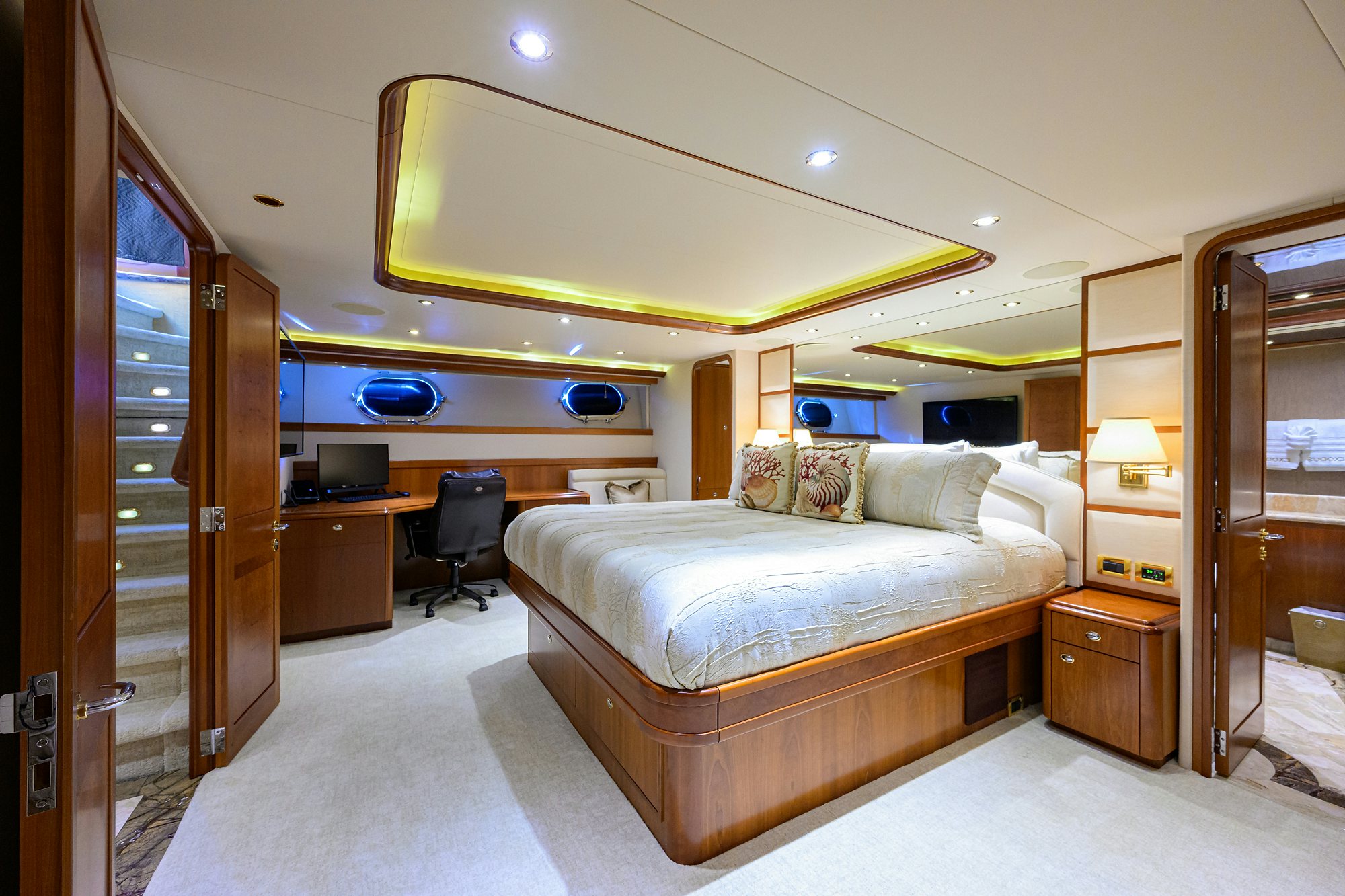 a bedroom with a bed and a desk aboard EXODUS Yacht for Sale