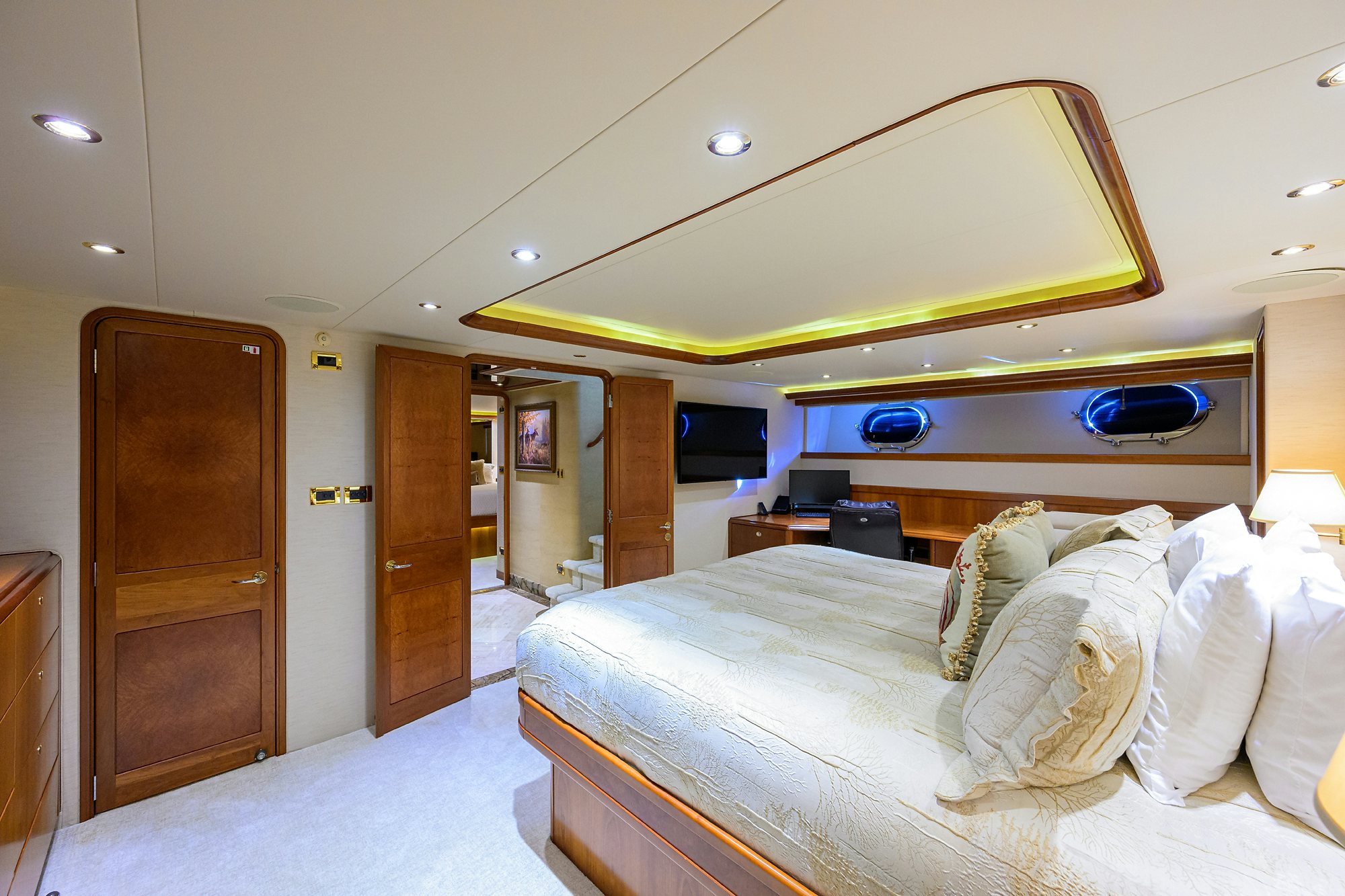 a bedroom with a bed and a desk aboard EXODUS Yacht for Sale
