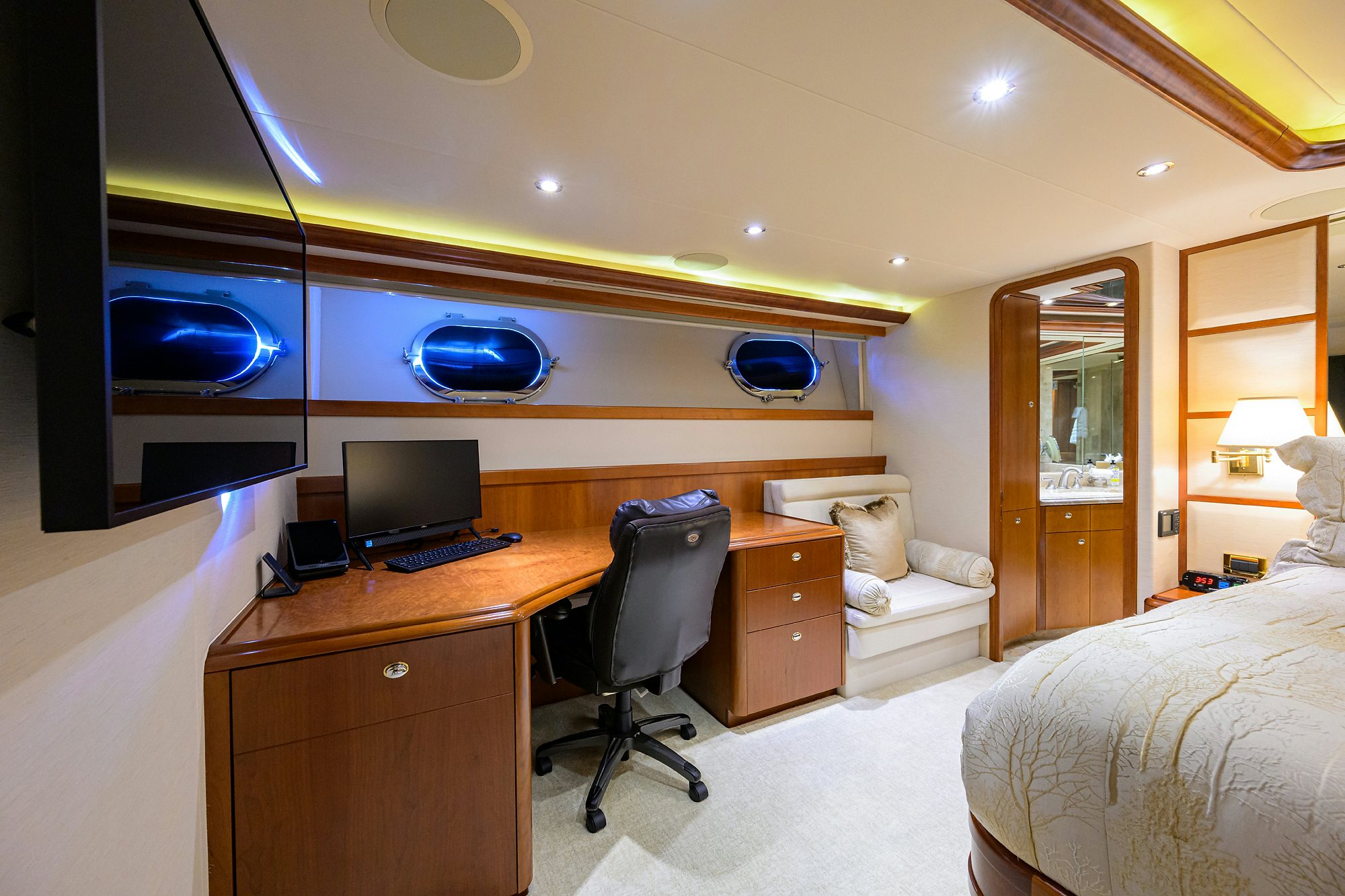 a bedroom with a desk and a bed aboard EXODUS Yacht for Sale
