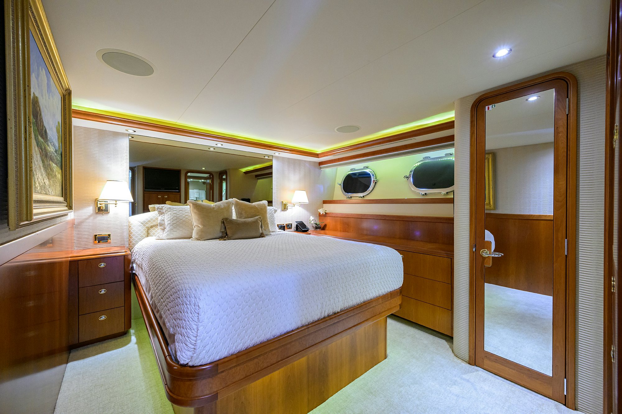 a hotel room with a bed and a mirror aboard EXODUS Yacht for Sale