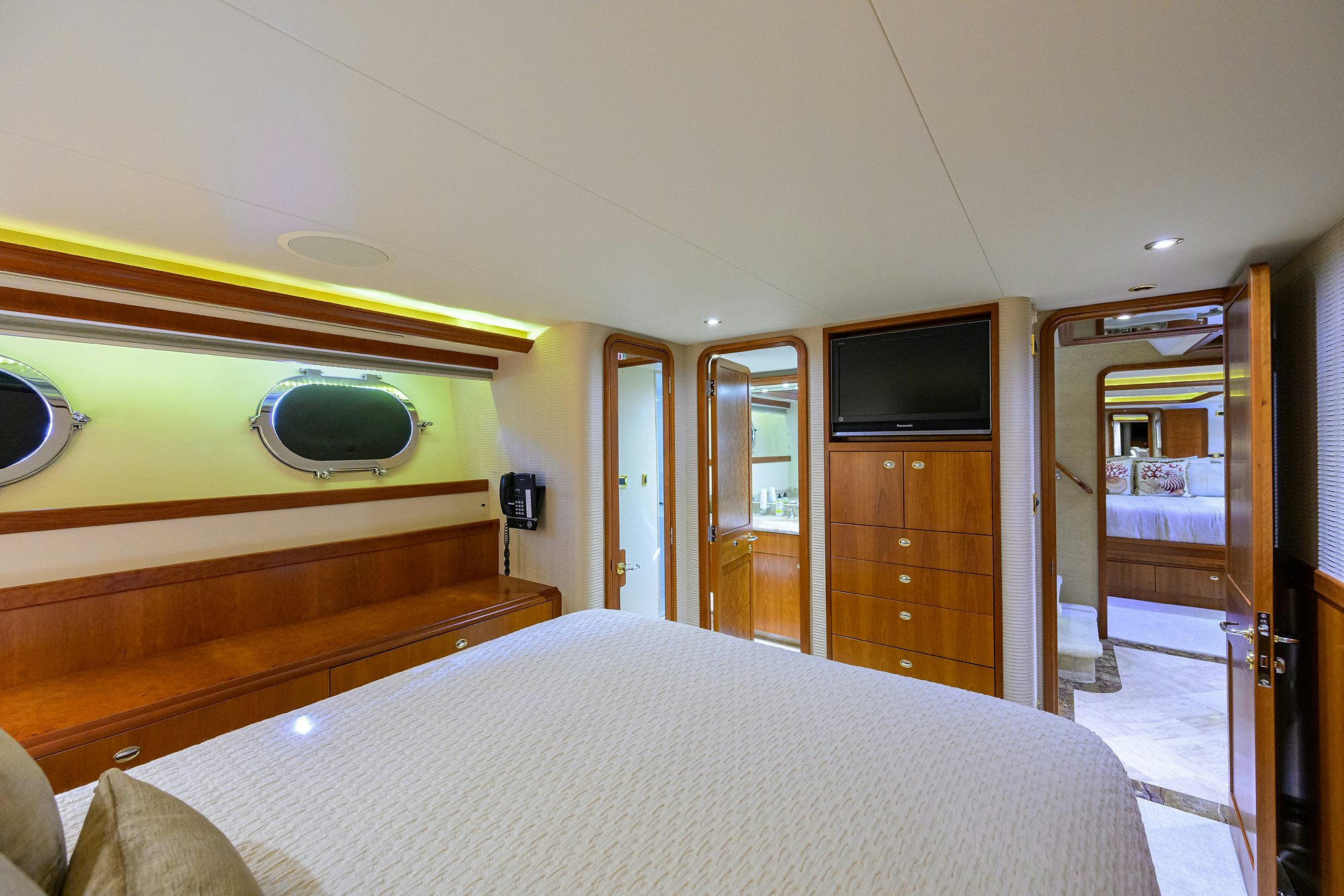 a bedroom with a bed and a television aboard EXODUS Yacht for Sale