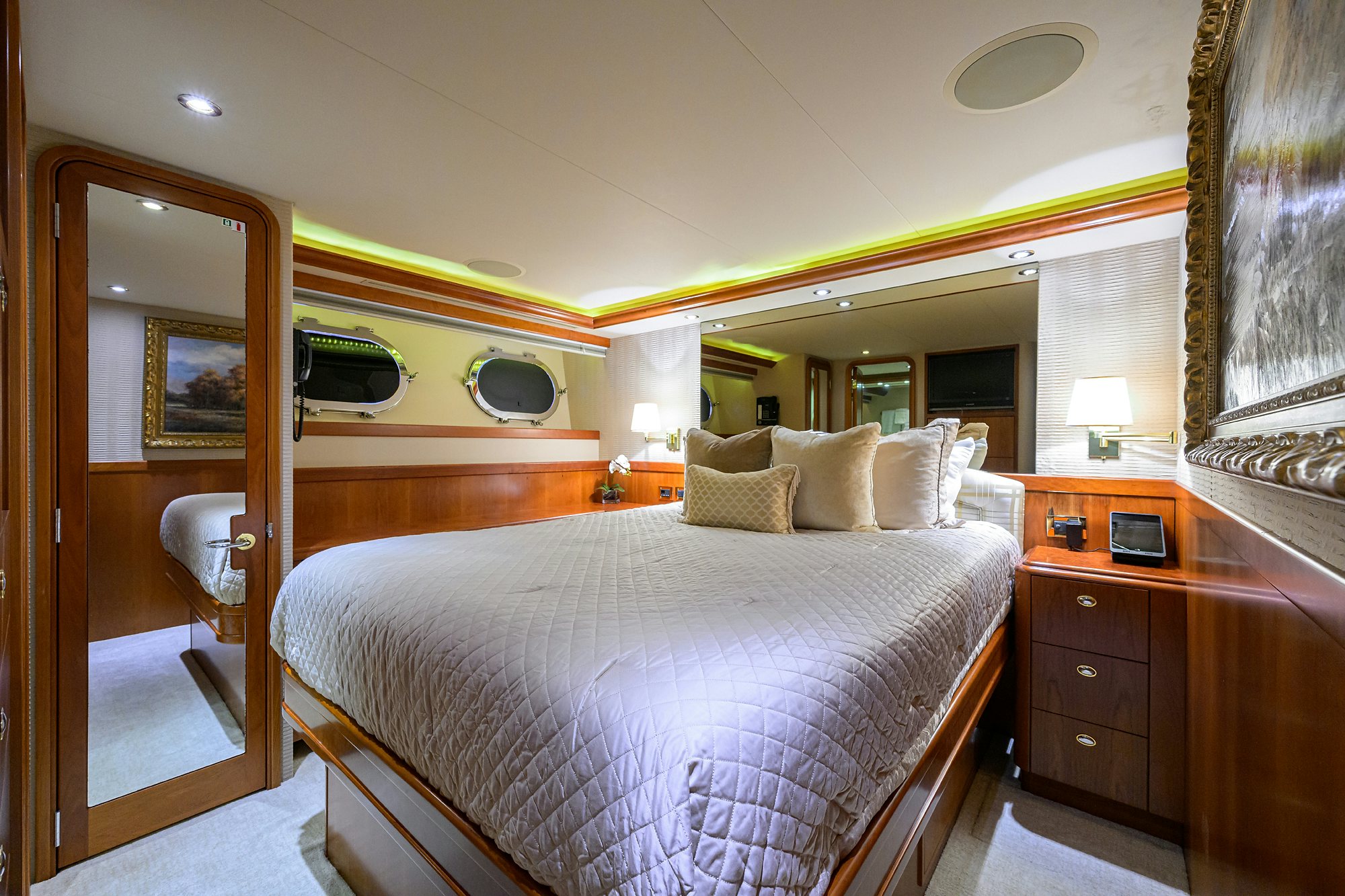 a bedroom with a bed and a mirror aboard EXODUS Yacht for Sale