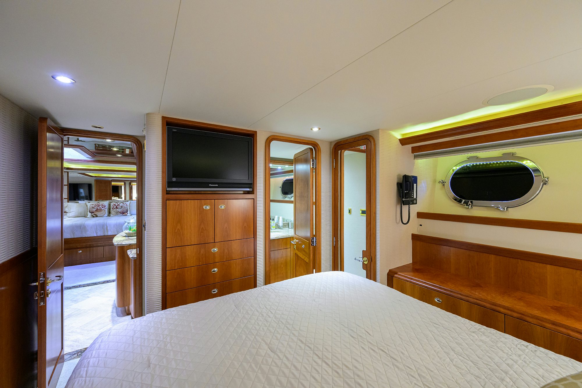 a bedroom with a bed and a television aboard EXODUS Yacht for Sale