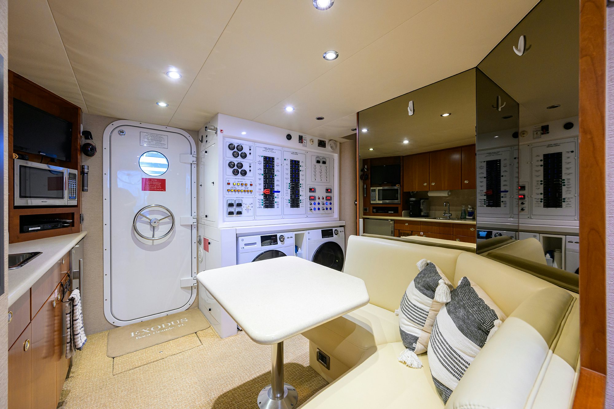 a room with a bed and a couch aboard EXODUS Yacht for Sale
