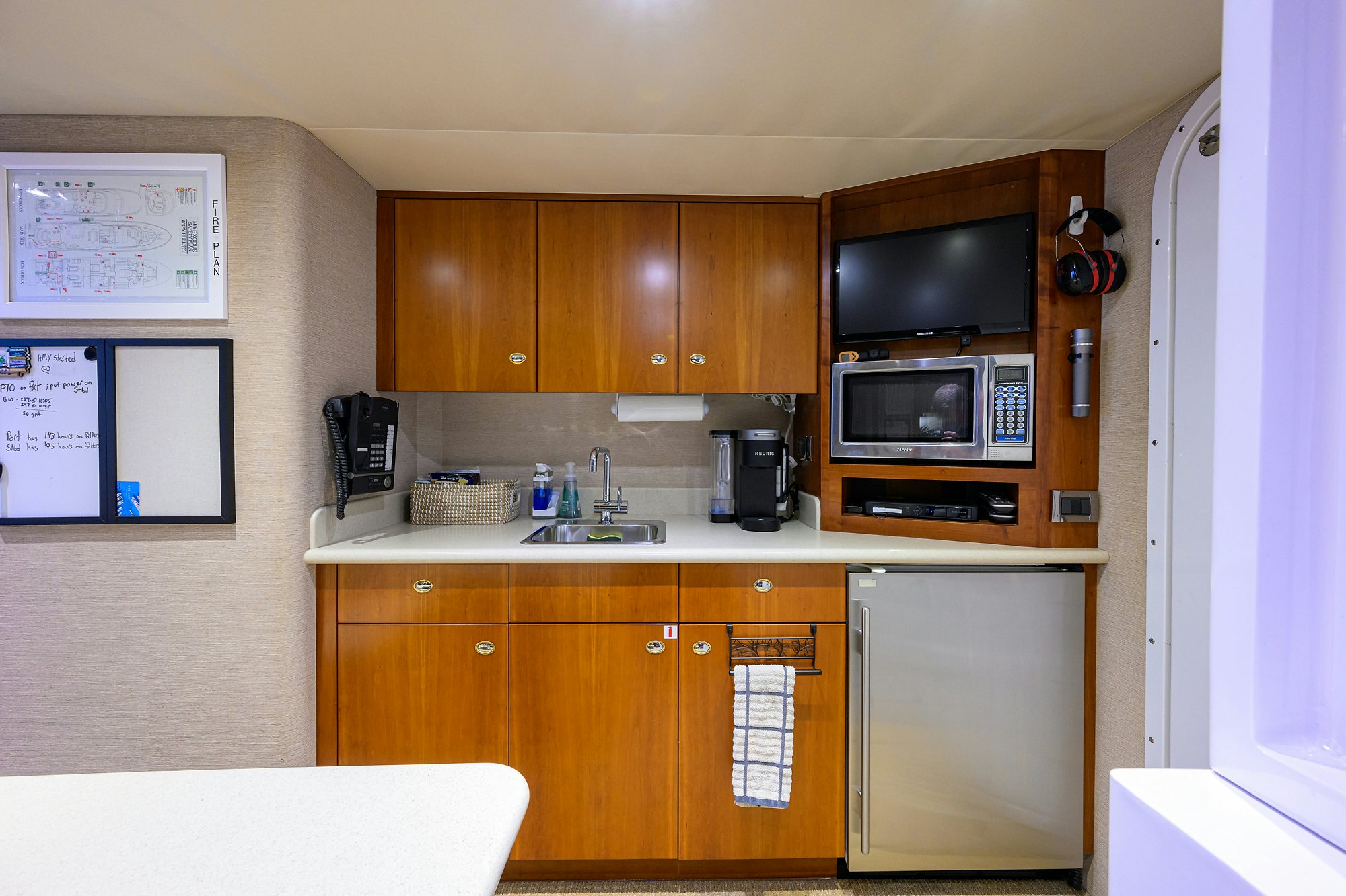 a kitchen with wooden cabinets aboard EXODUS Yacht for Sale